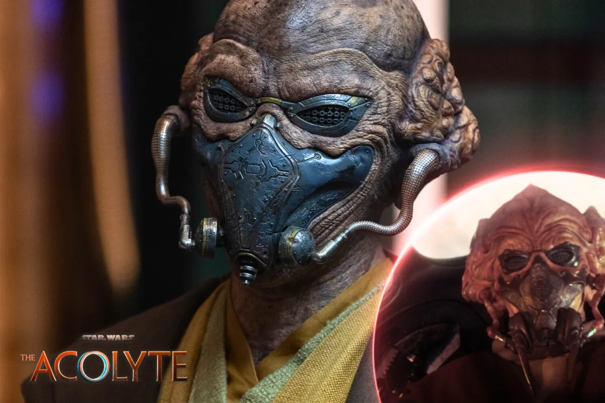 Close-up of Ithia Paan from Star Wars: The Acolyte, wearing an ornate breathing mask and goggles. The intricate metal detailing on the mask gives it an aged, ceremonial appearance. An inset image compares the character to Jedi Master Plo Koon, highlighting fan speculation about their connection.