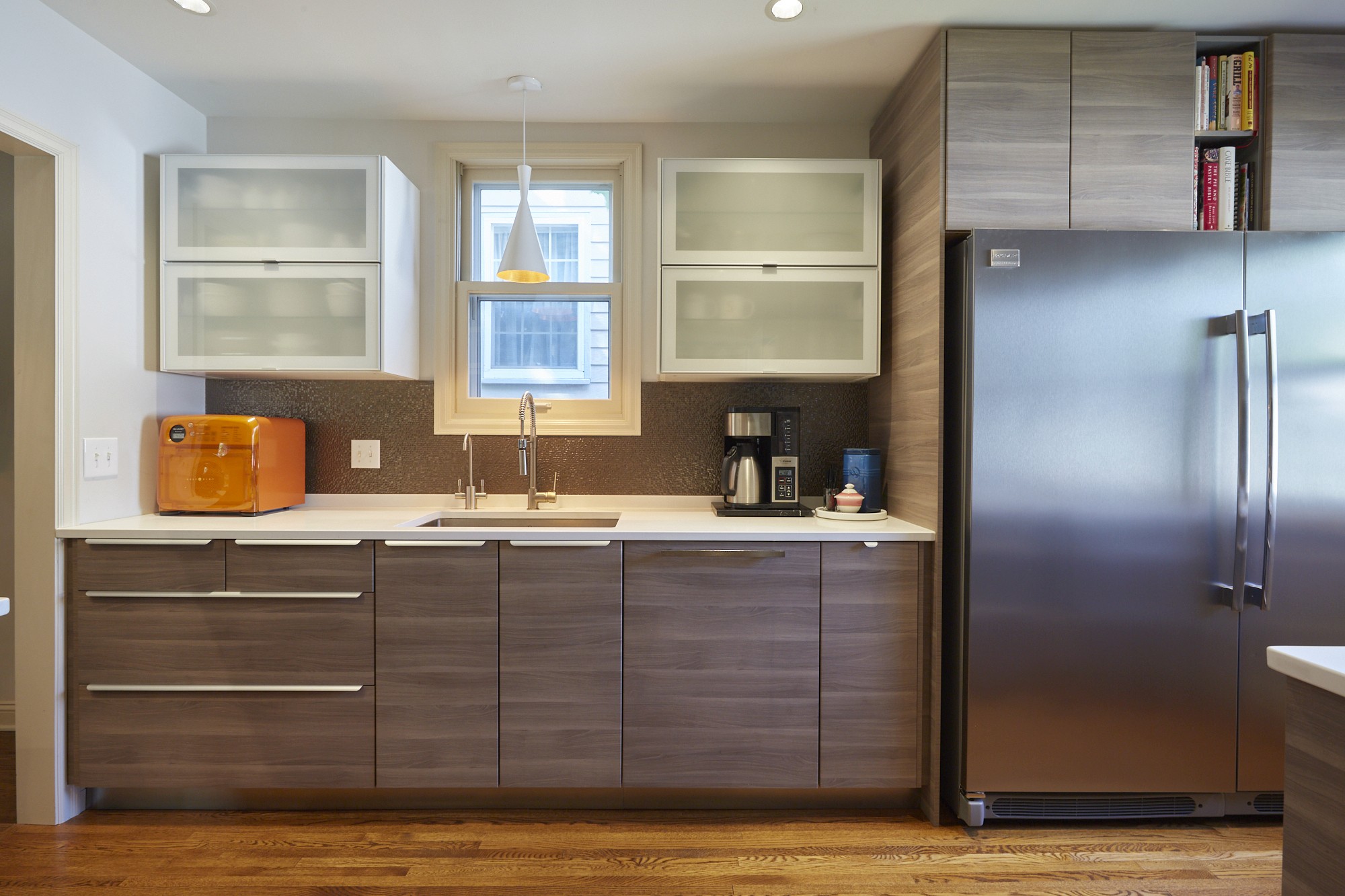 Gray cabinetry with glass-front uppers and mosaic backsplash in the Diamond Lake kitchen