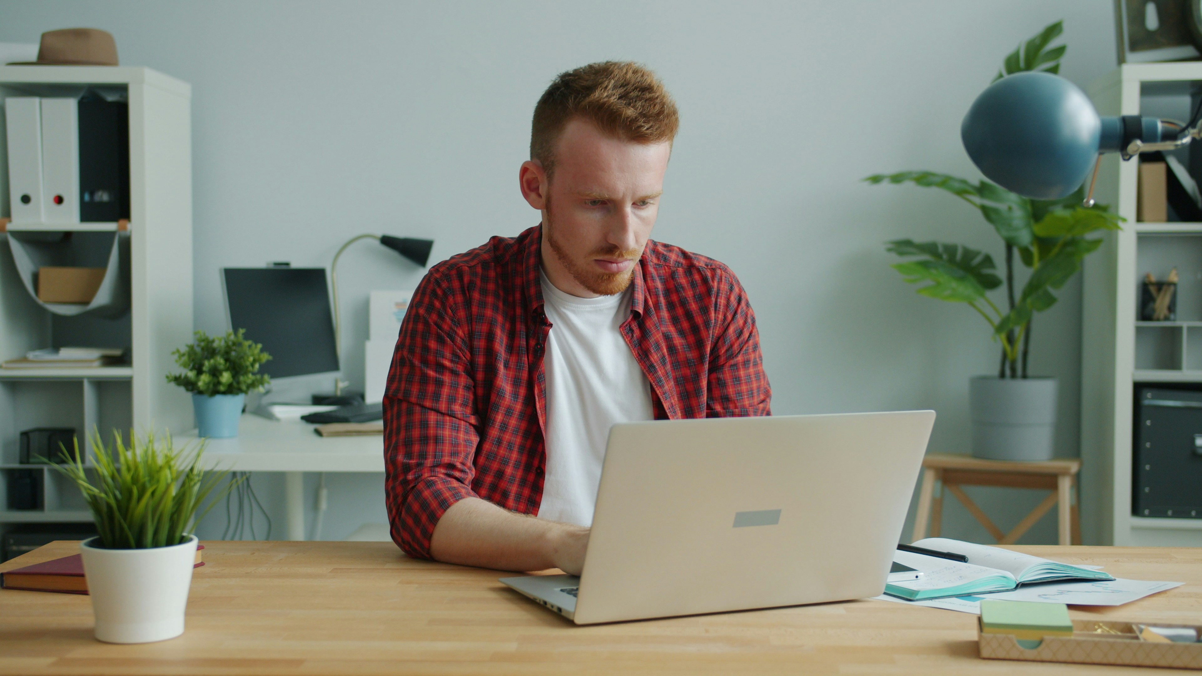 Man working on a laptop at a desk.