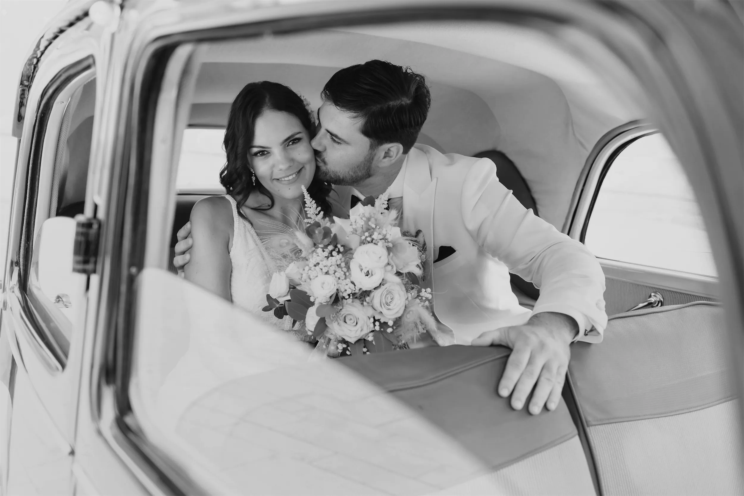 Artistic close-up of bride’s hands holding bouquet at emotional wedding ceremony