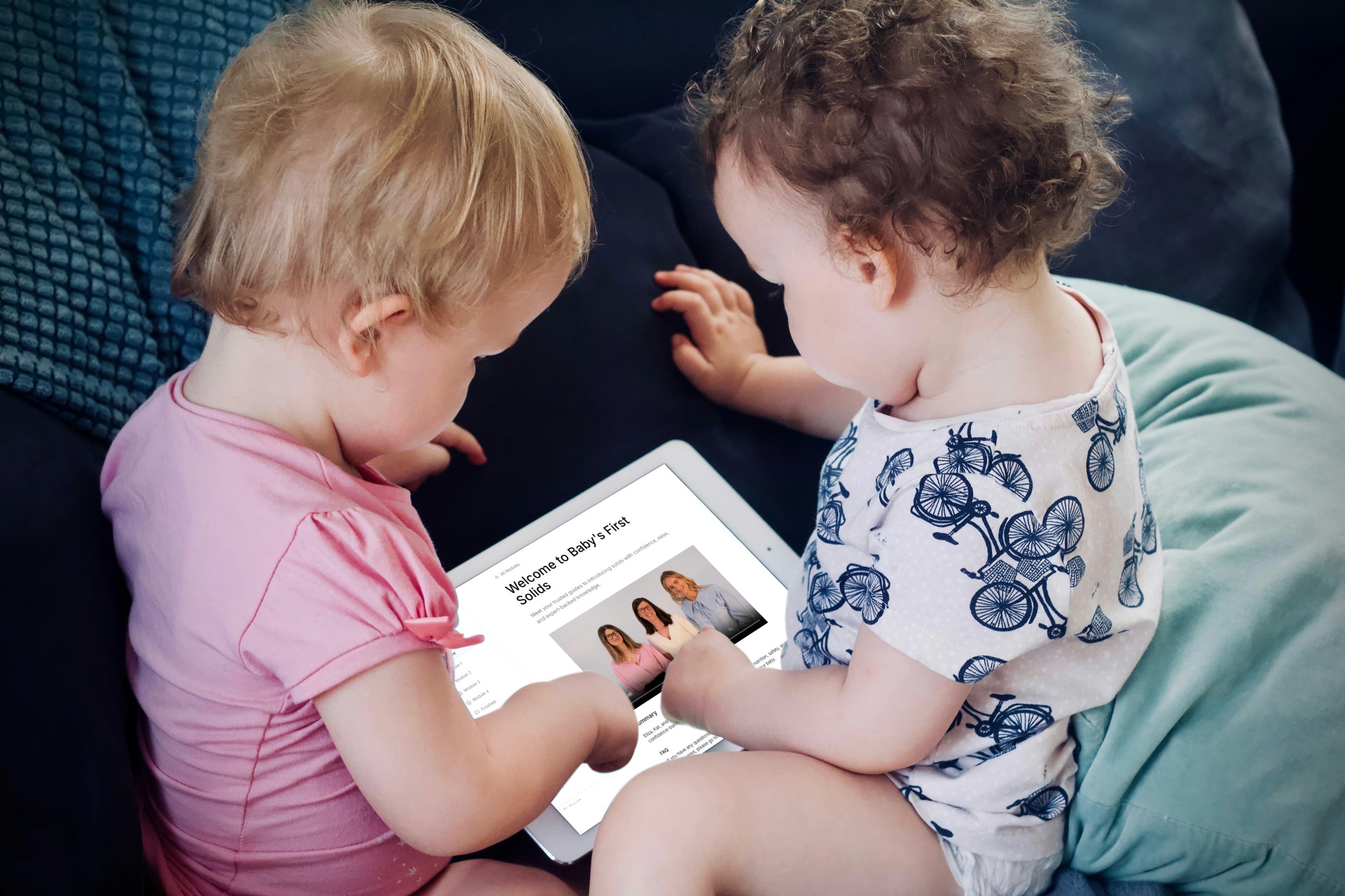 Two Baby's Holding Ipad Looking At Baby's First Solids Course