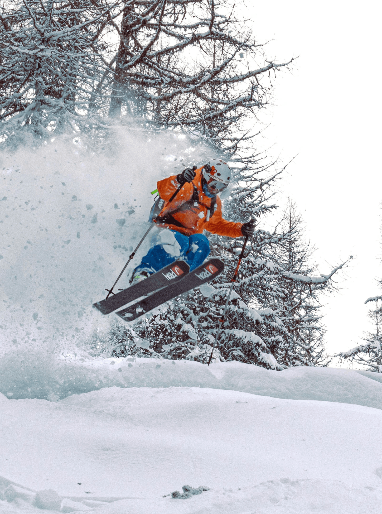 person in orange jacket riding snowboard on snow covered ground during daytime