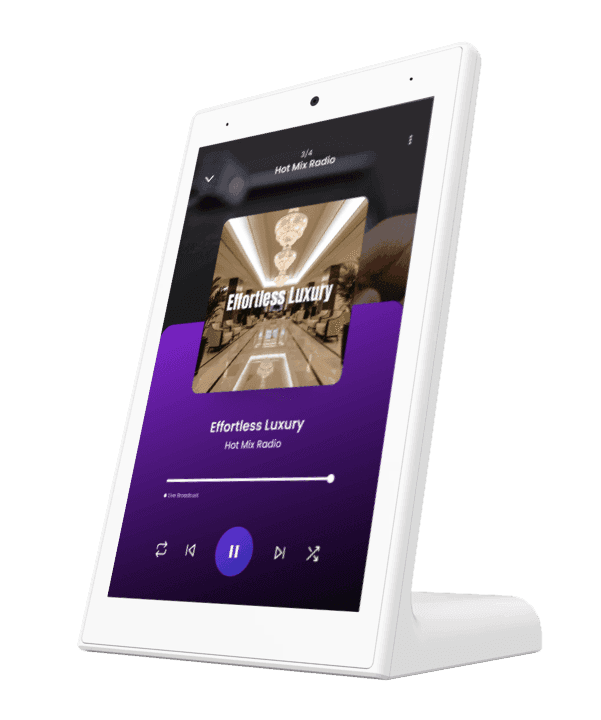 A digital monitor displaying various images and content in a grid layout, set on a white stand.