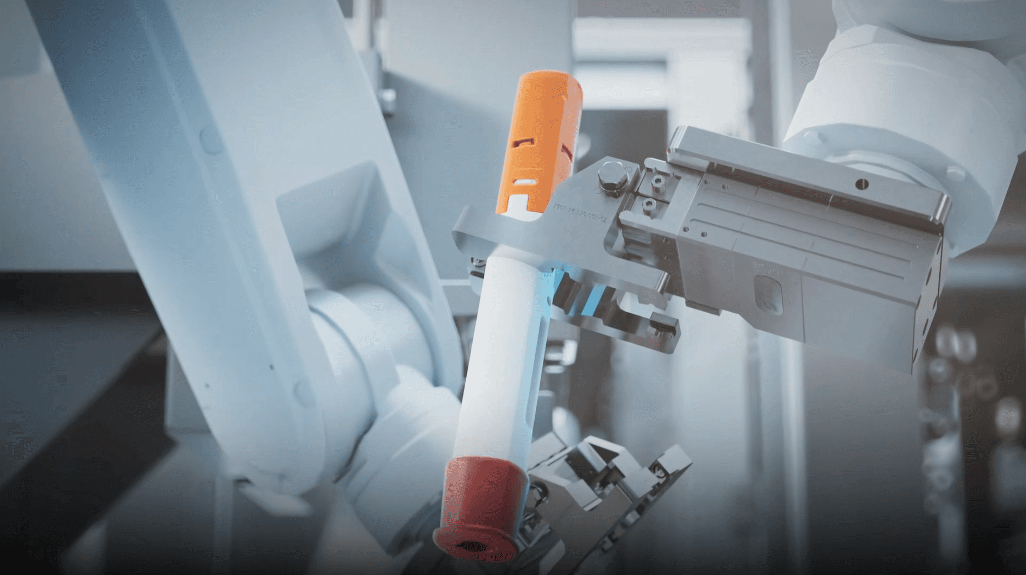 industrial robot arm is holding a syringe