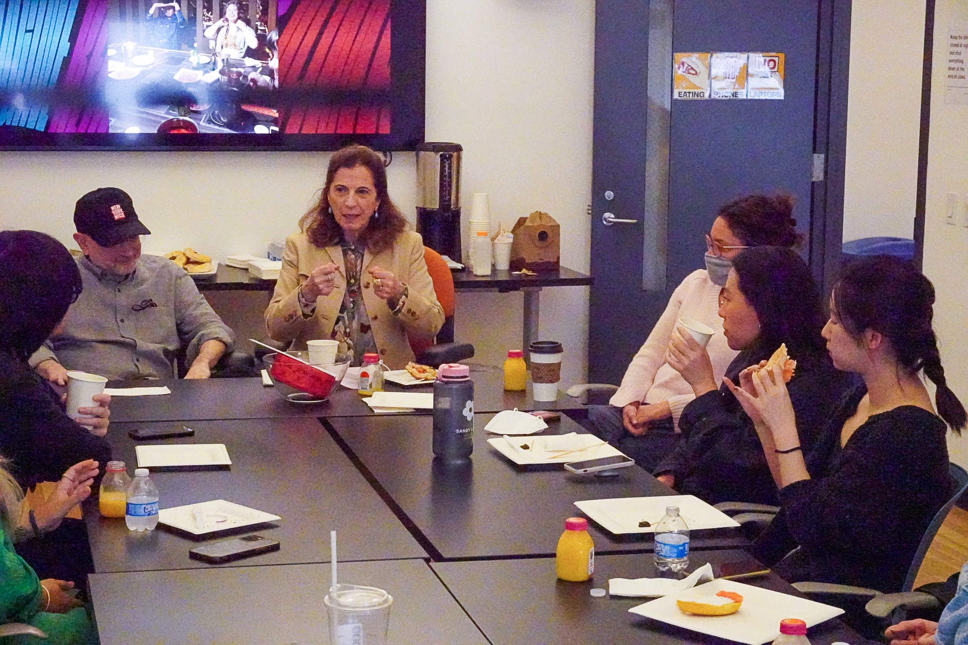 A photo of a group of people sitting at a conference table in an office room.