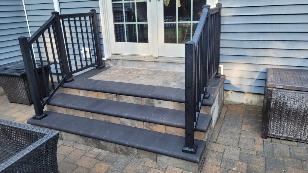 black modern railing on outdoor steps to sliding door