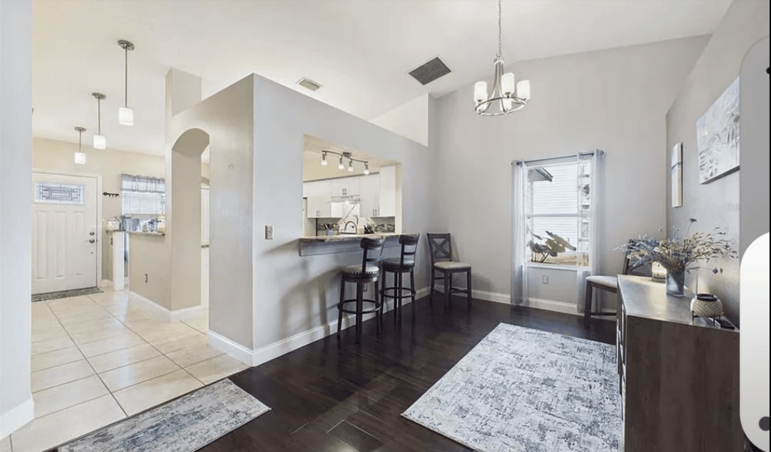 white wooden kitchen cabinet with black pendant lamp