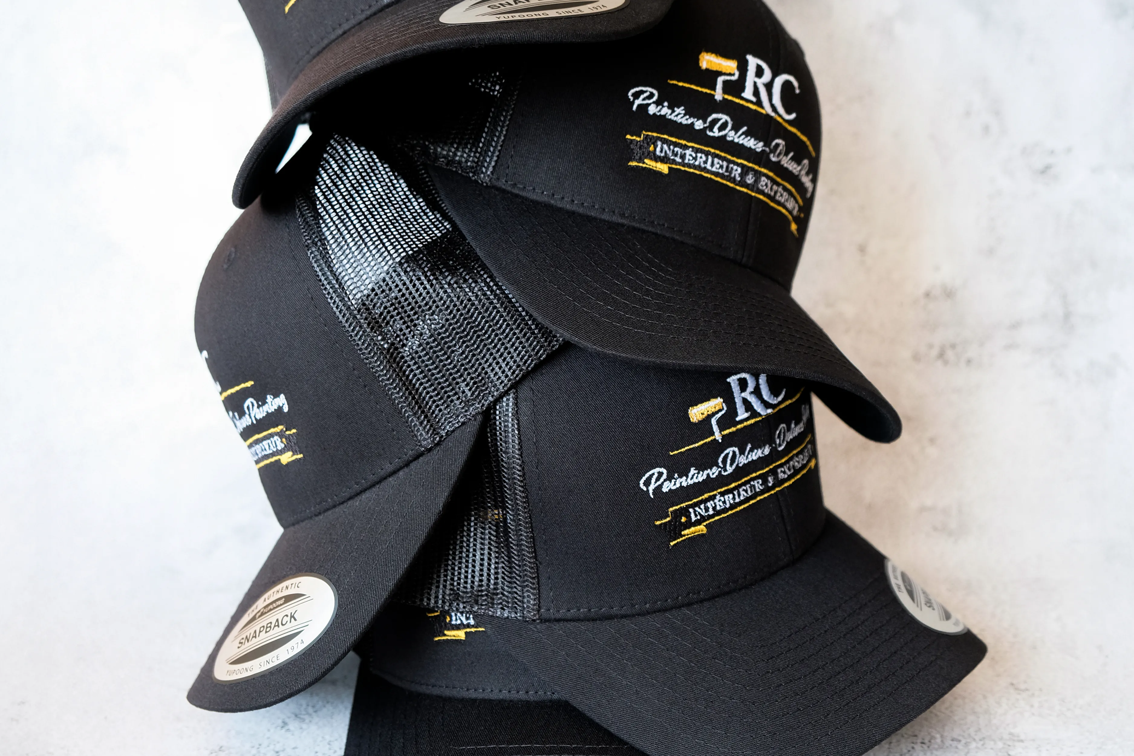 Embroidery on custom caps, polos, and hoodies in Montreal and Laval