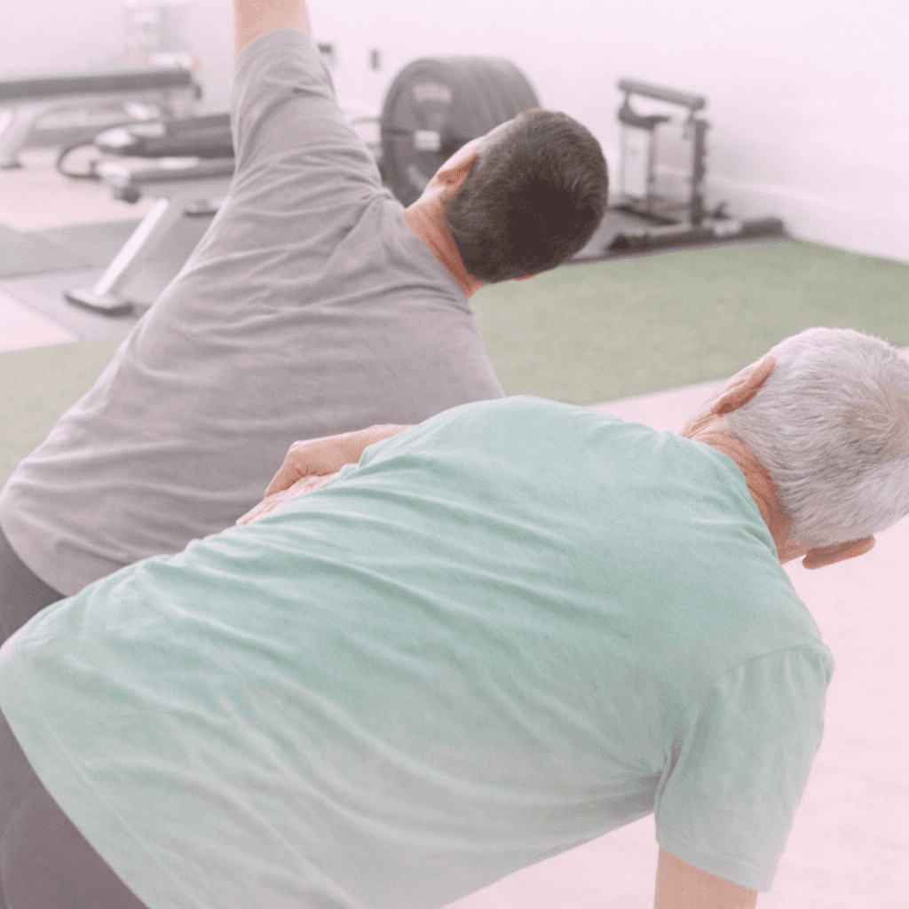 a couple of men standing on top of a yoga mat
