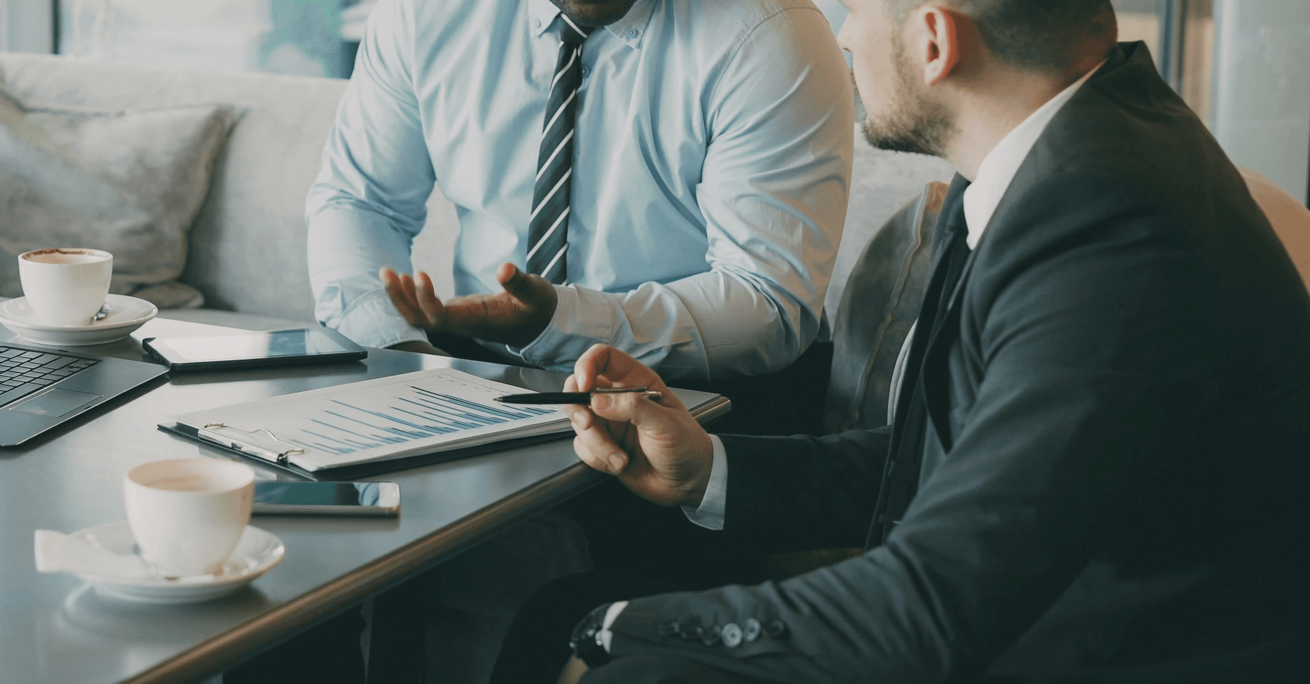 Two professionals discussing documents during a meeting