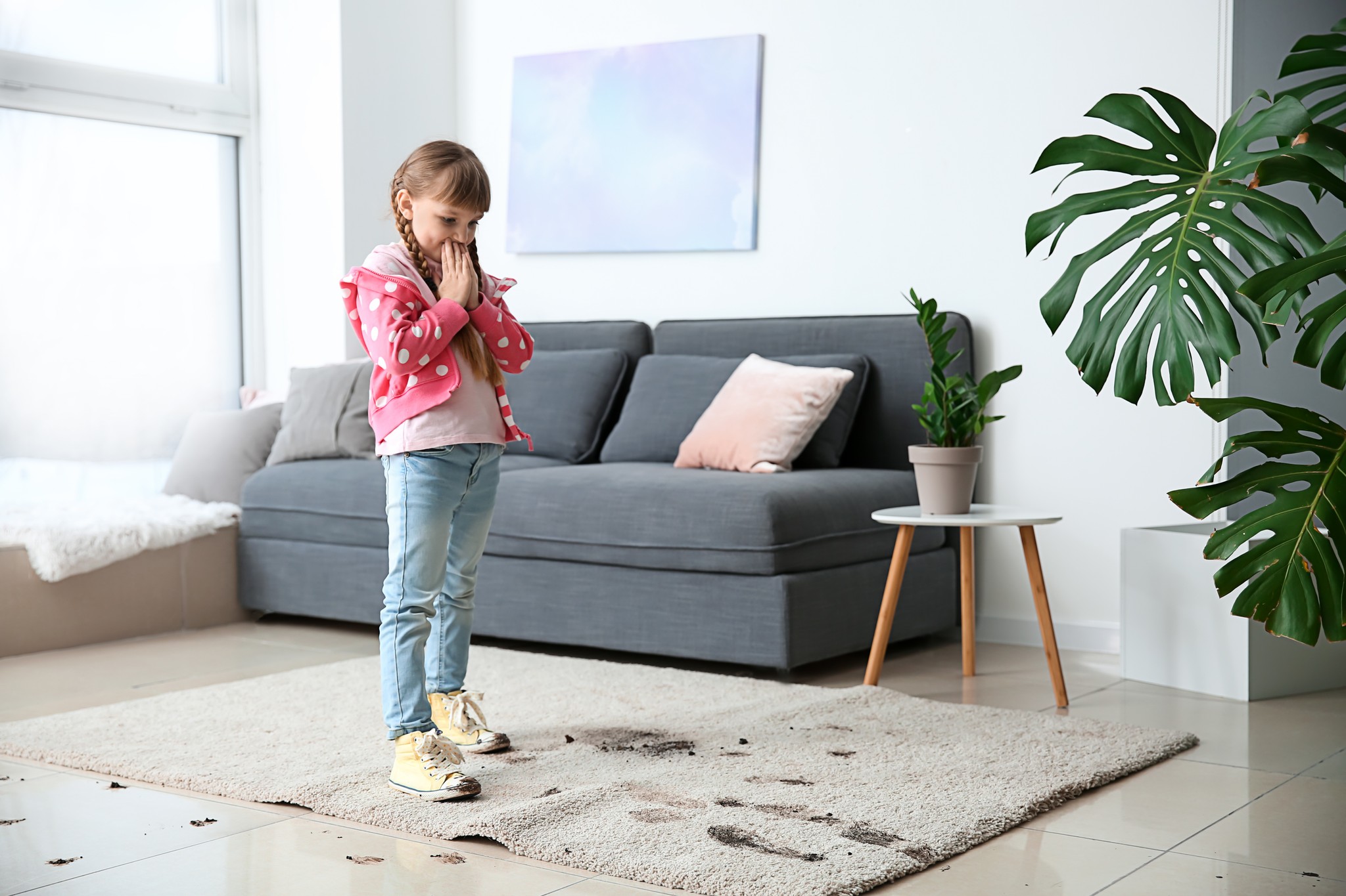 Girl looking at dirty carpet