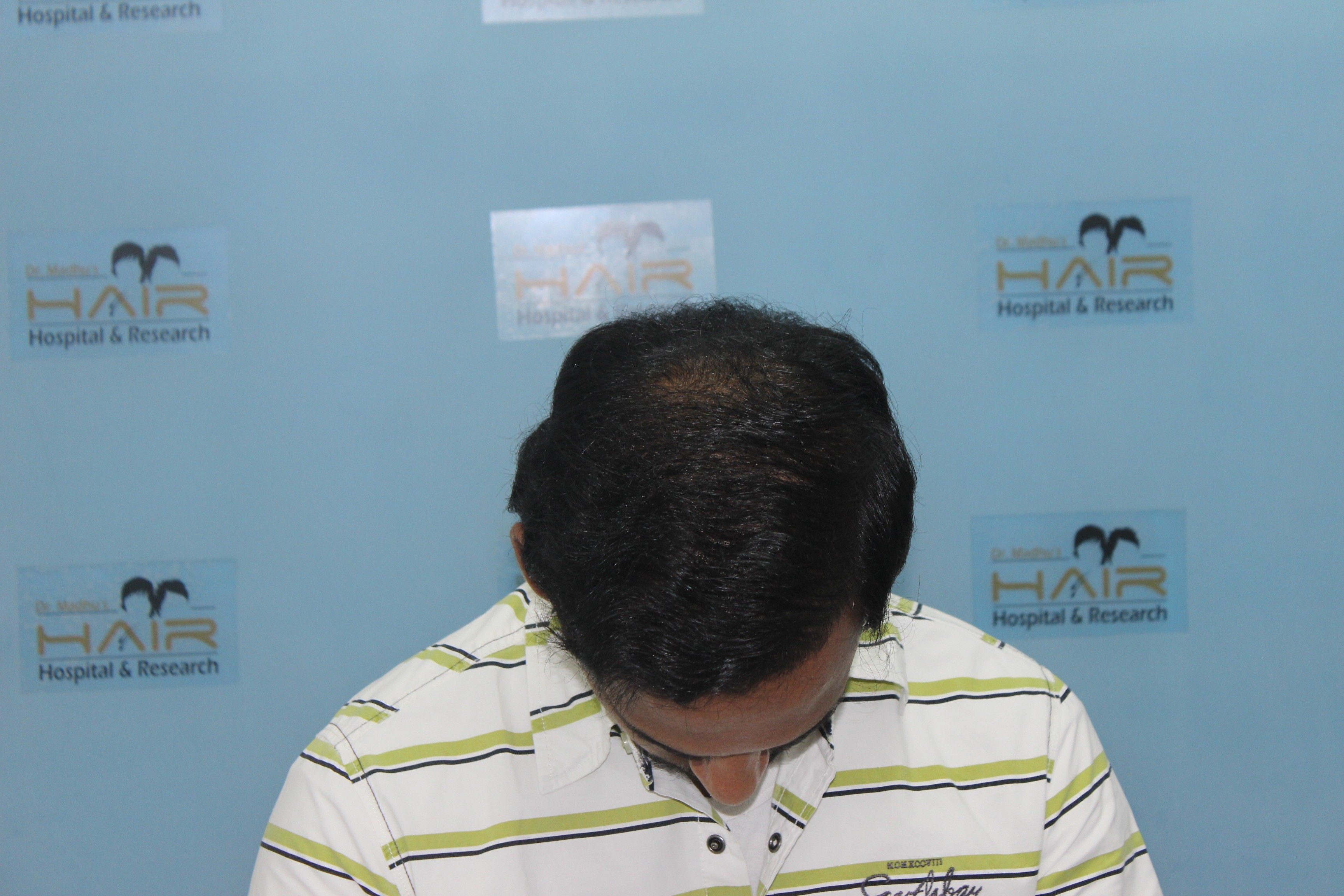 Smiling person with wet skin and short hair