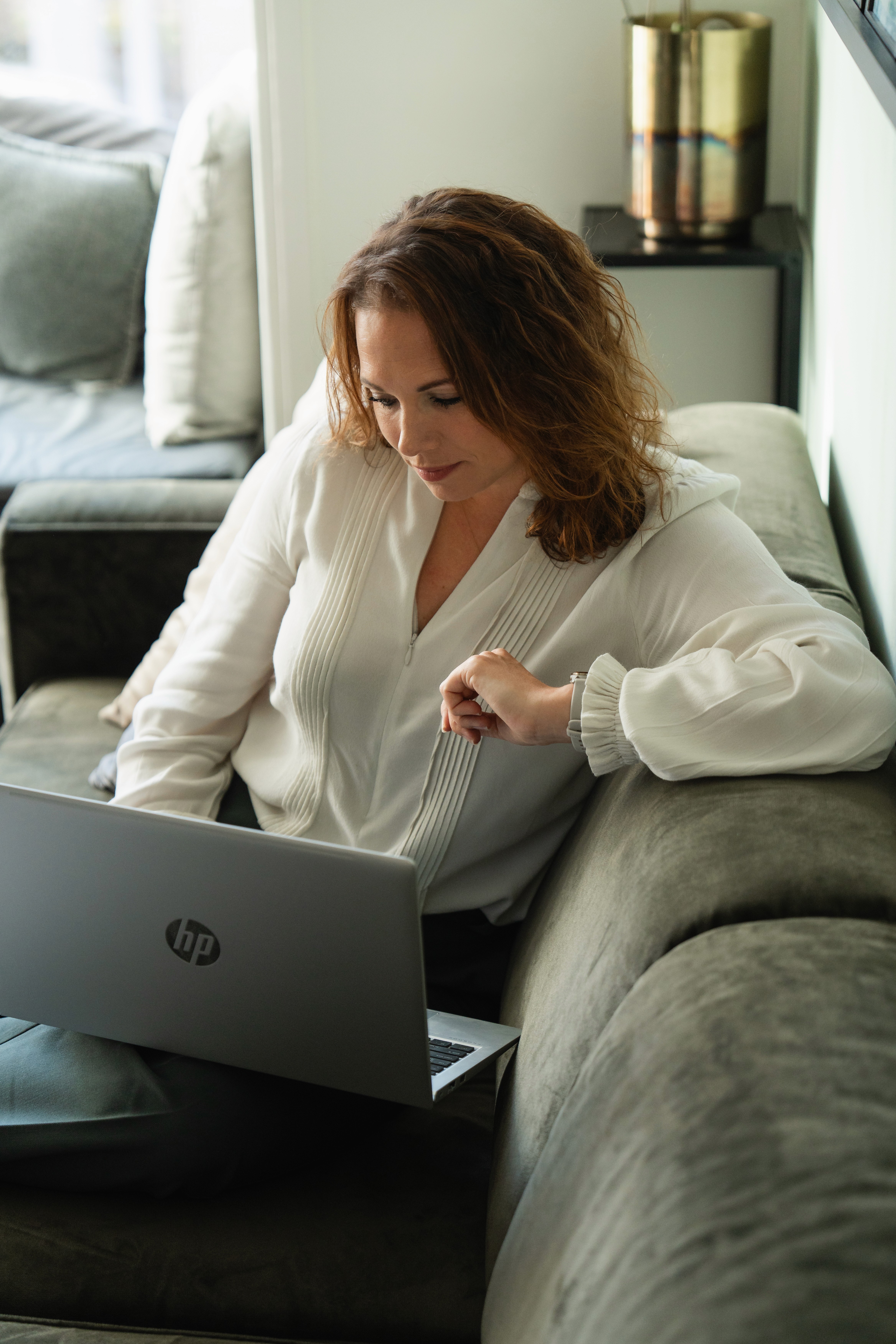 woman in brown coat using macbook air