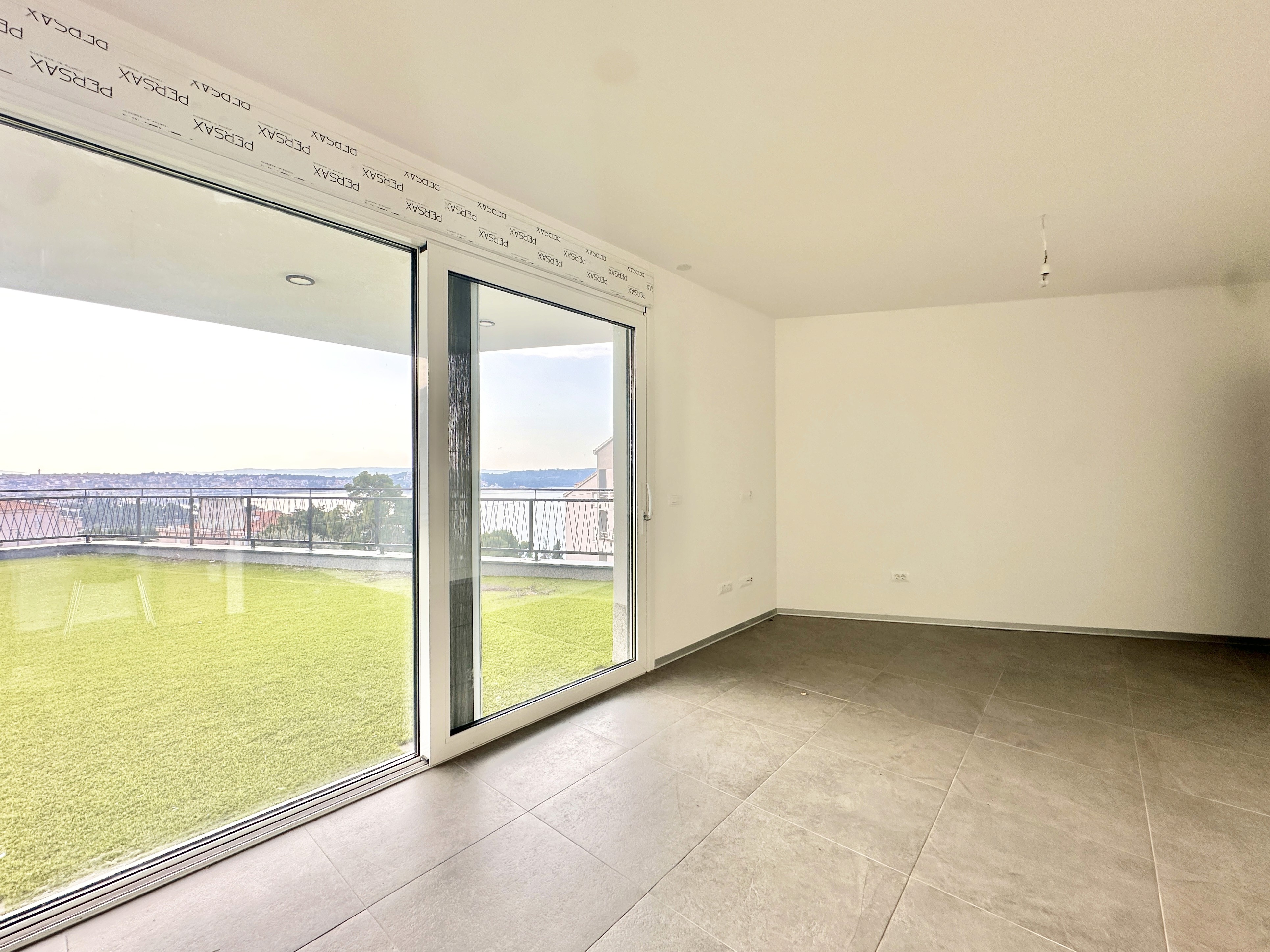 Bedroom with wall bookshelf and mountain view.