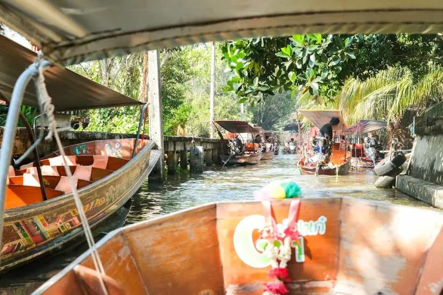 Traditional Thai longtail boats moored along a canal at a Bangkok floating market