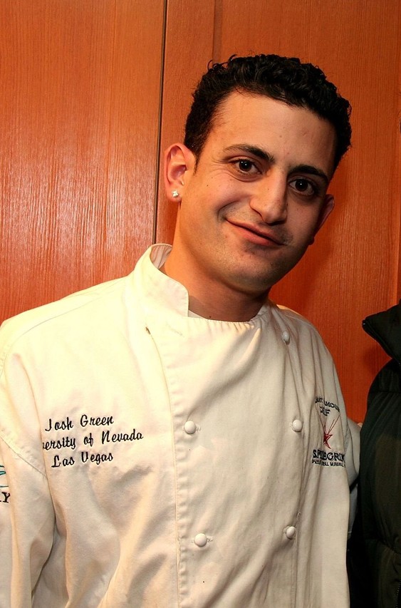 two people looking at a tablet and smiling