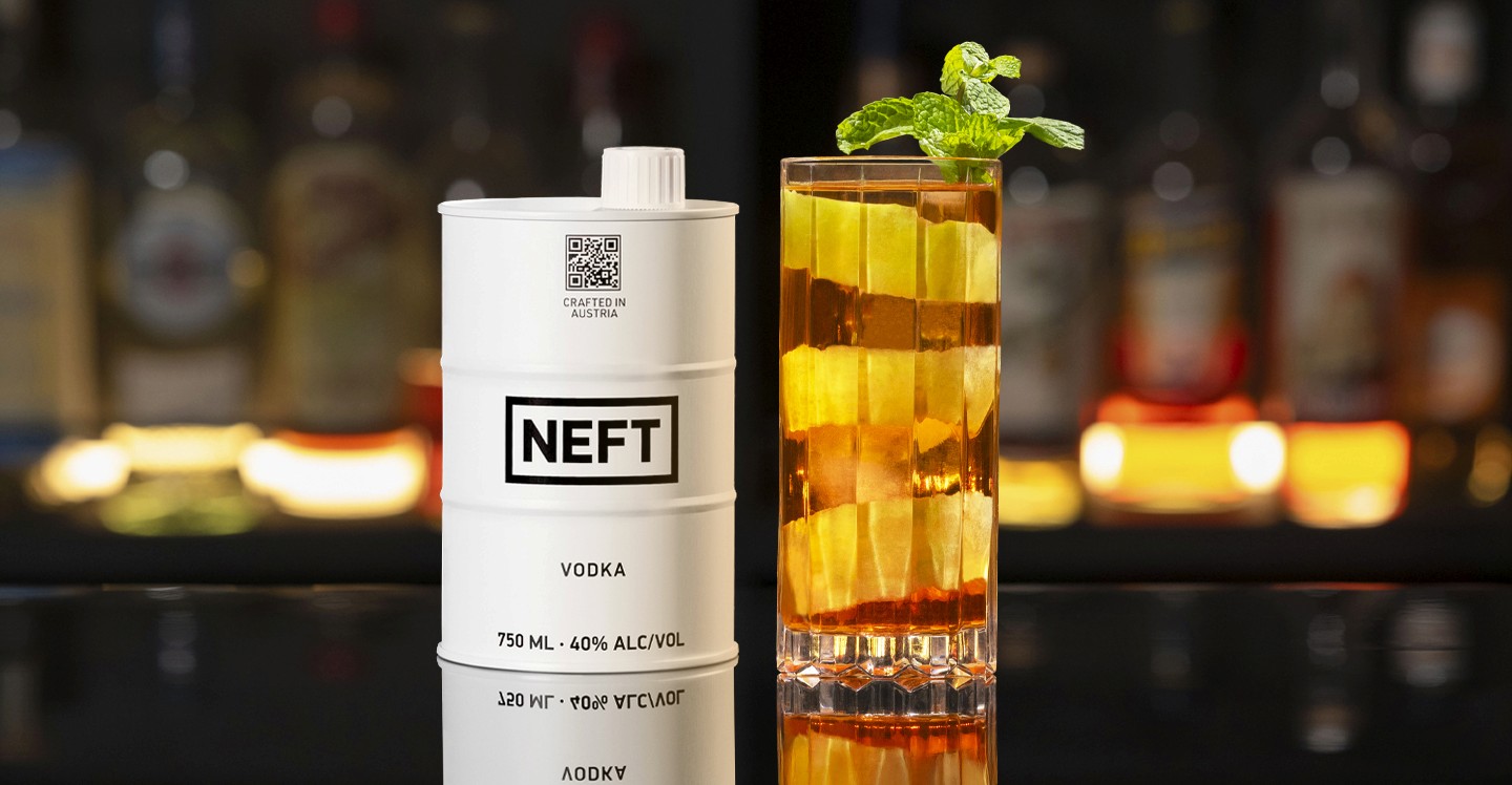A NEFT Barrel and a glass of Minnelli on a bar counter.