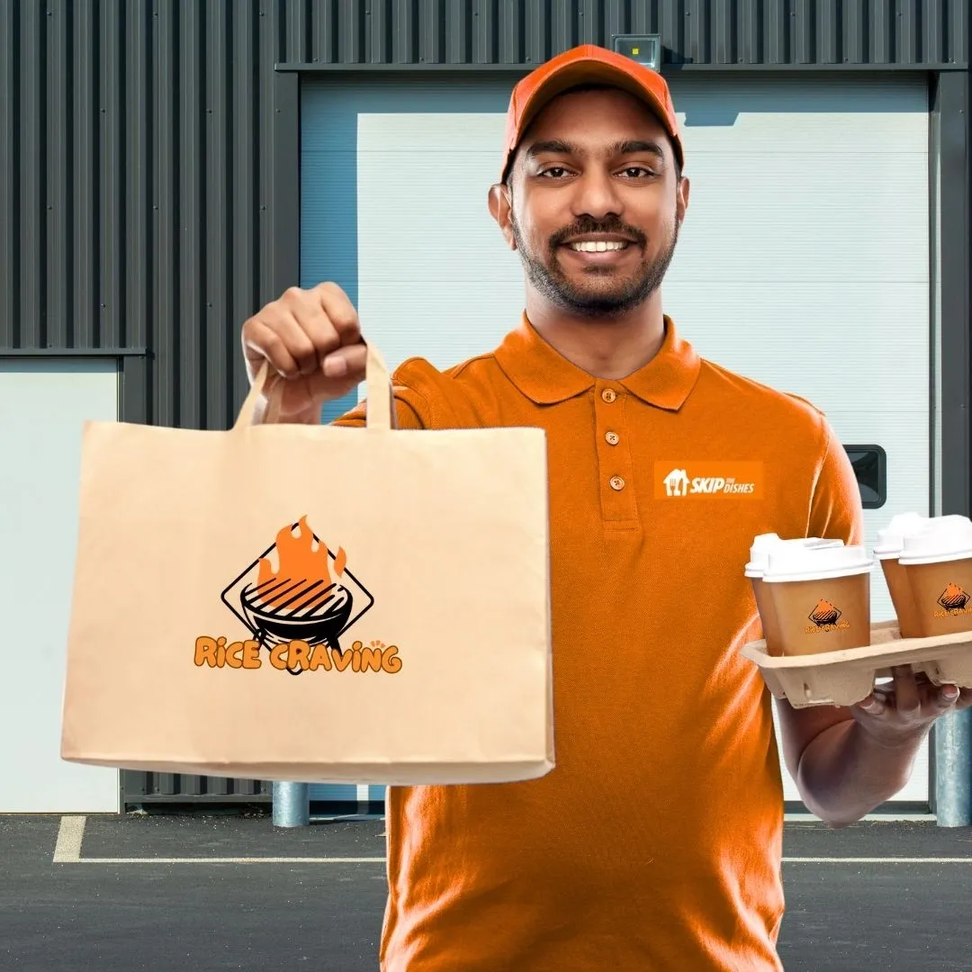 A food delivery driver in an orange polo and cap holding out a paper bag and a tray of coffee cups.