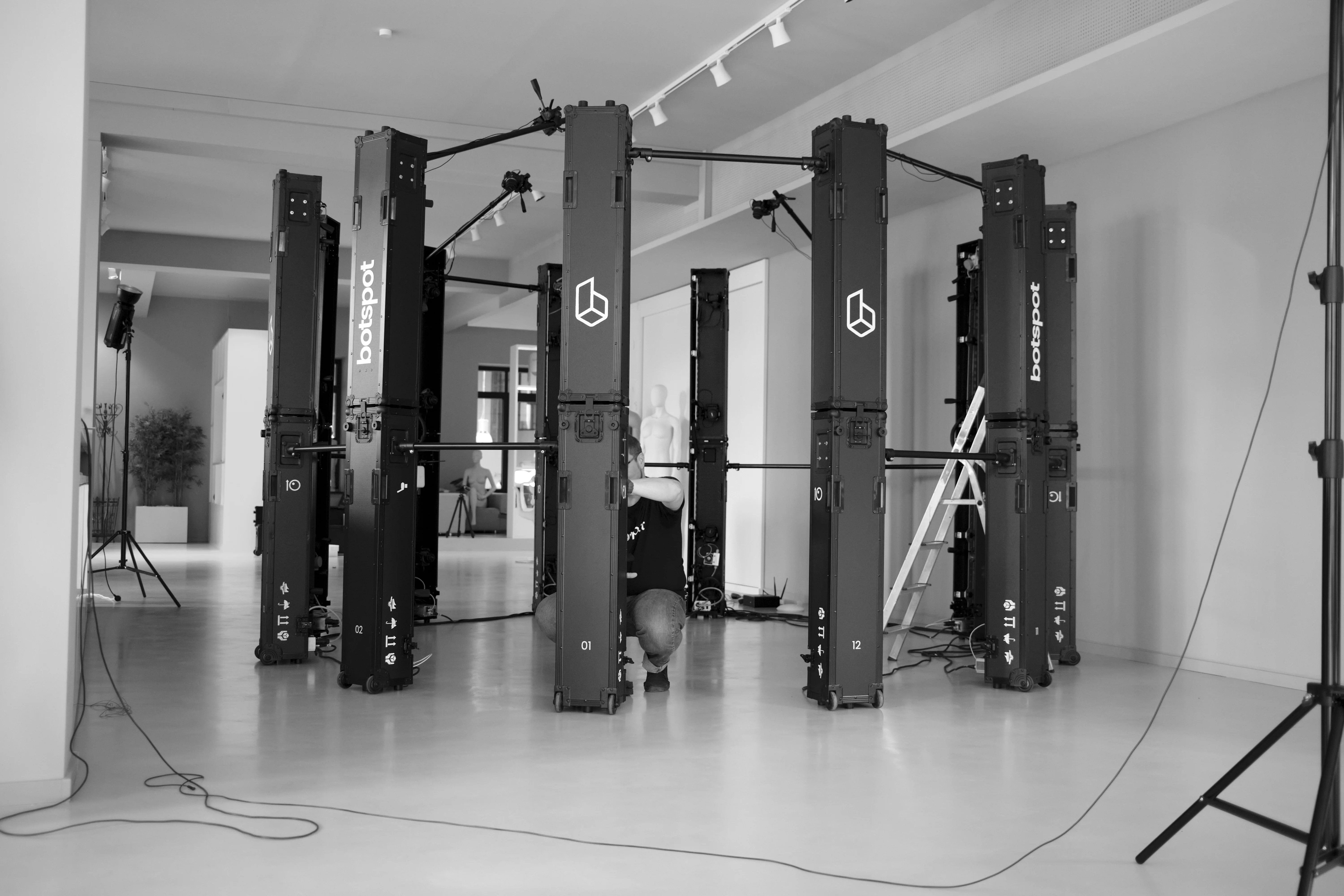 A botspot employee fine-tuning the camera angle on one of the FLEX cases, getting the scanner ready to scan.