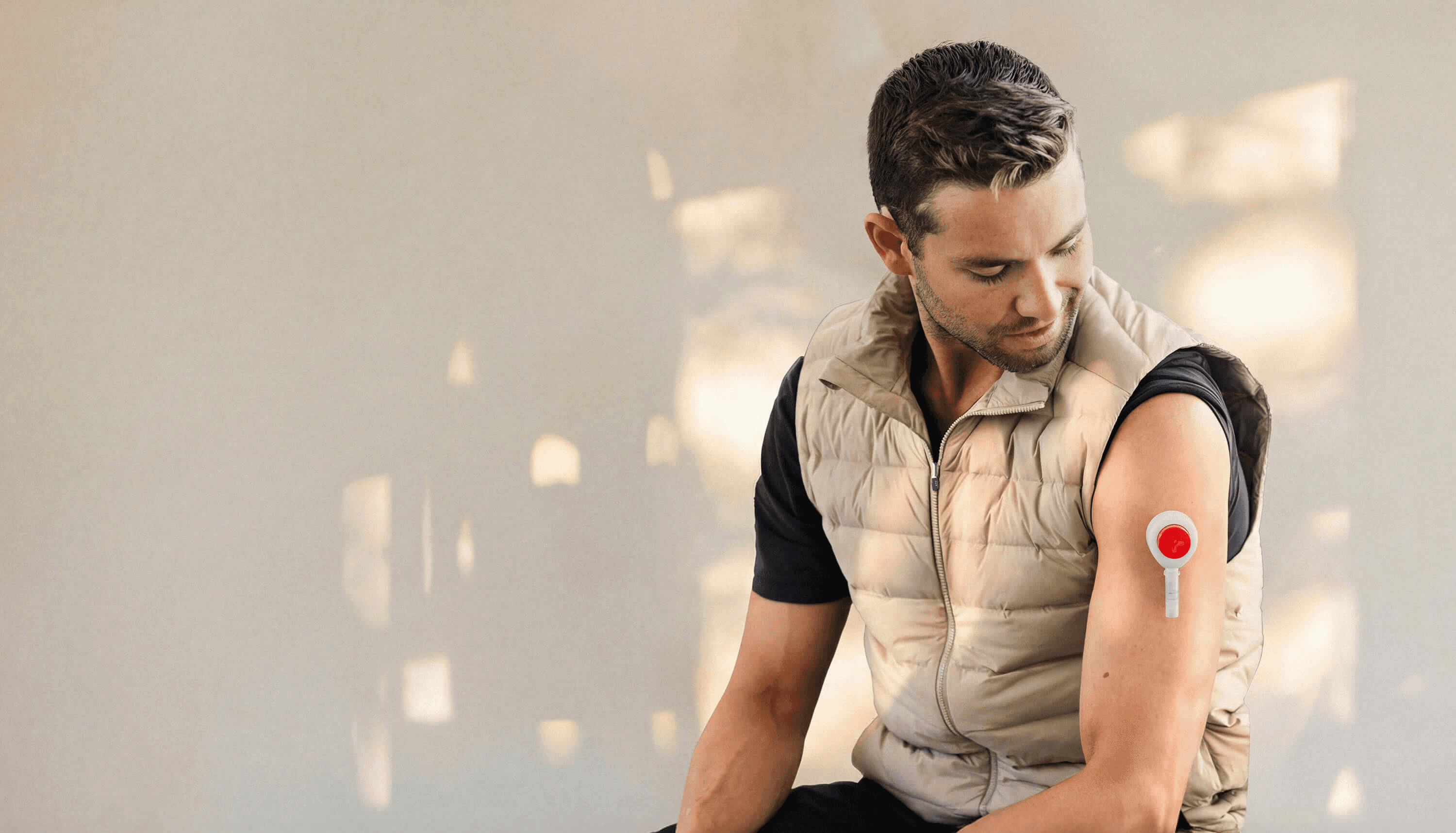 Man collecting a blood sample from his upper arm using an at-home test kit.