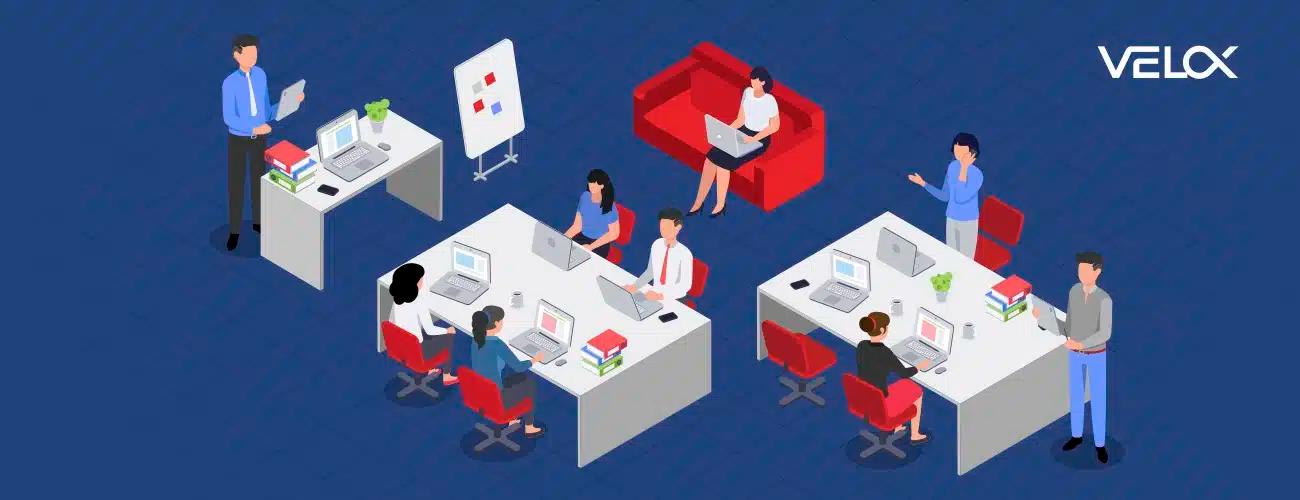 Multiple people sitting at their computer desks in an office setting