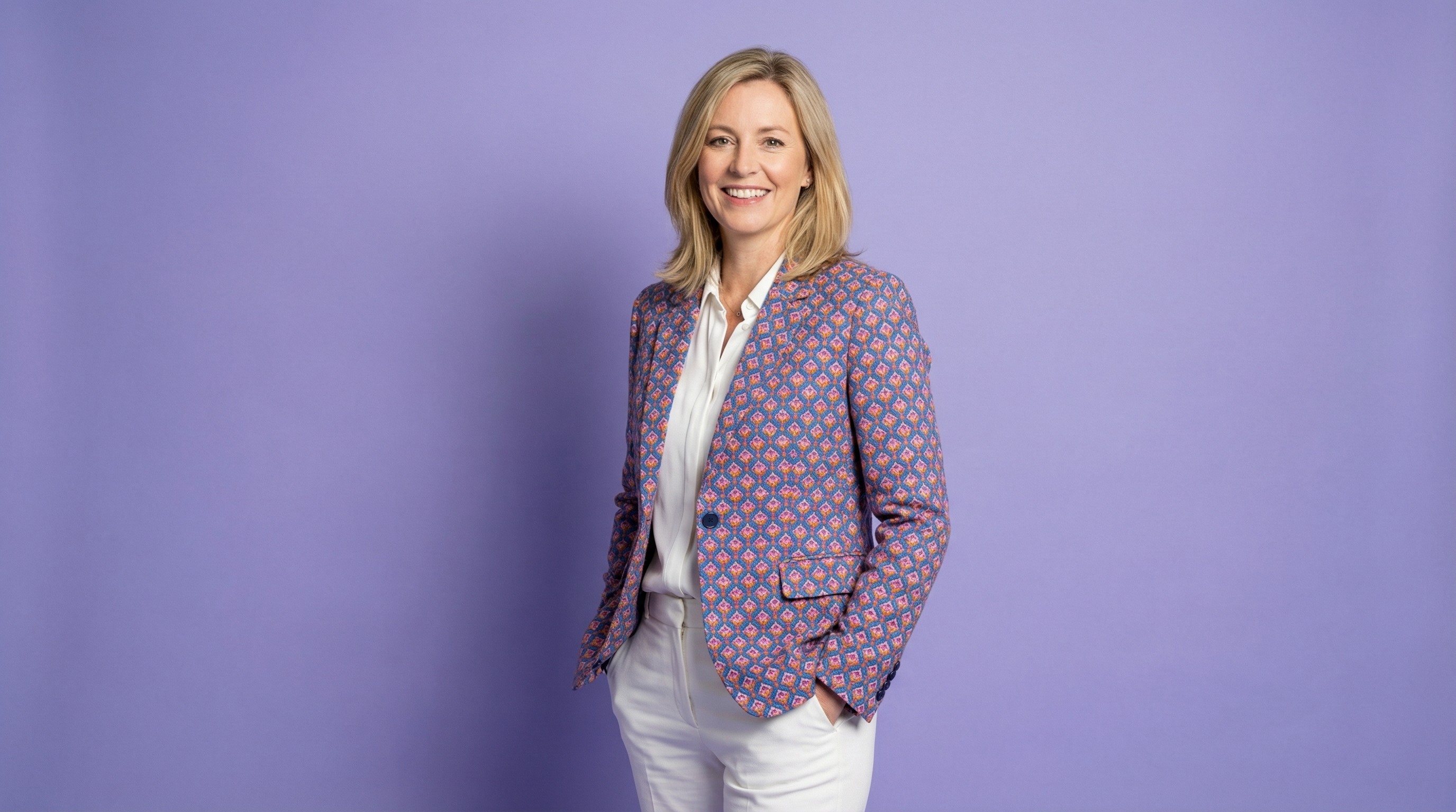 Close-up of lush, dark green leaves, some glossy and wet, against a muted background.