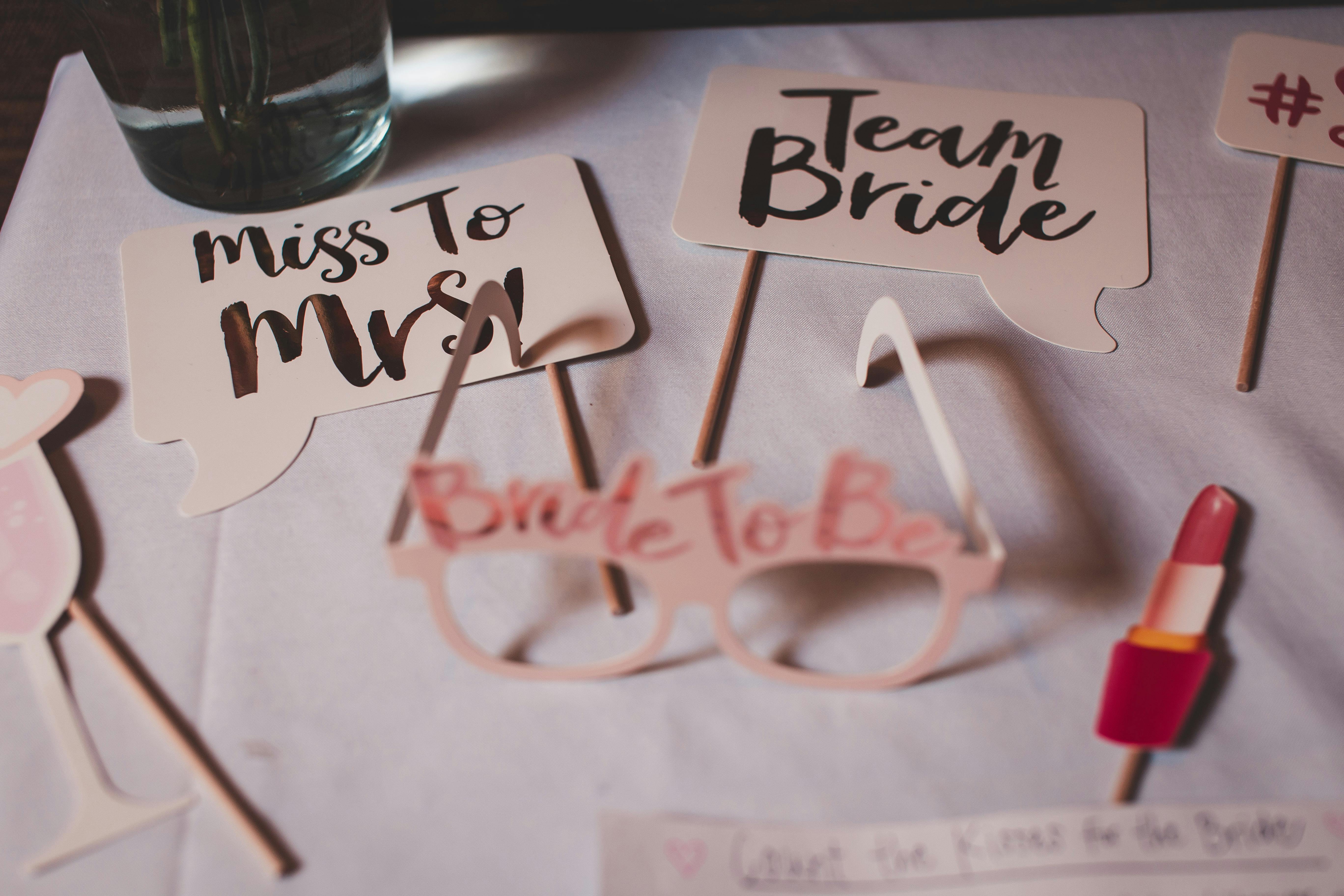 Bridal party balloon setup with champagne glasses and Bride and Mrs signs arranged for a bachelorette celebration