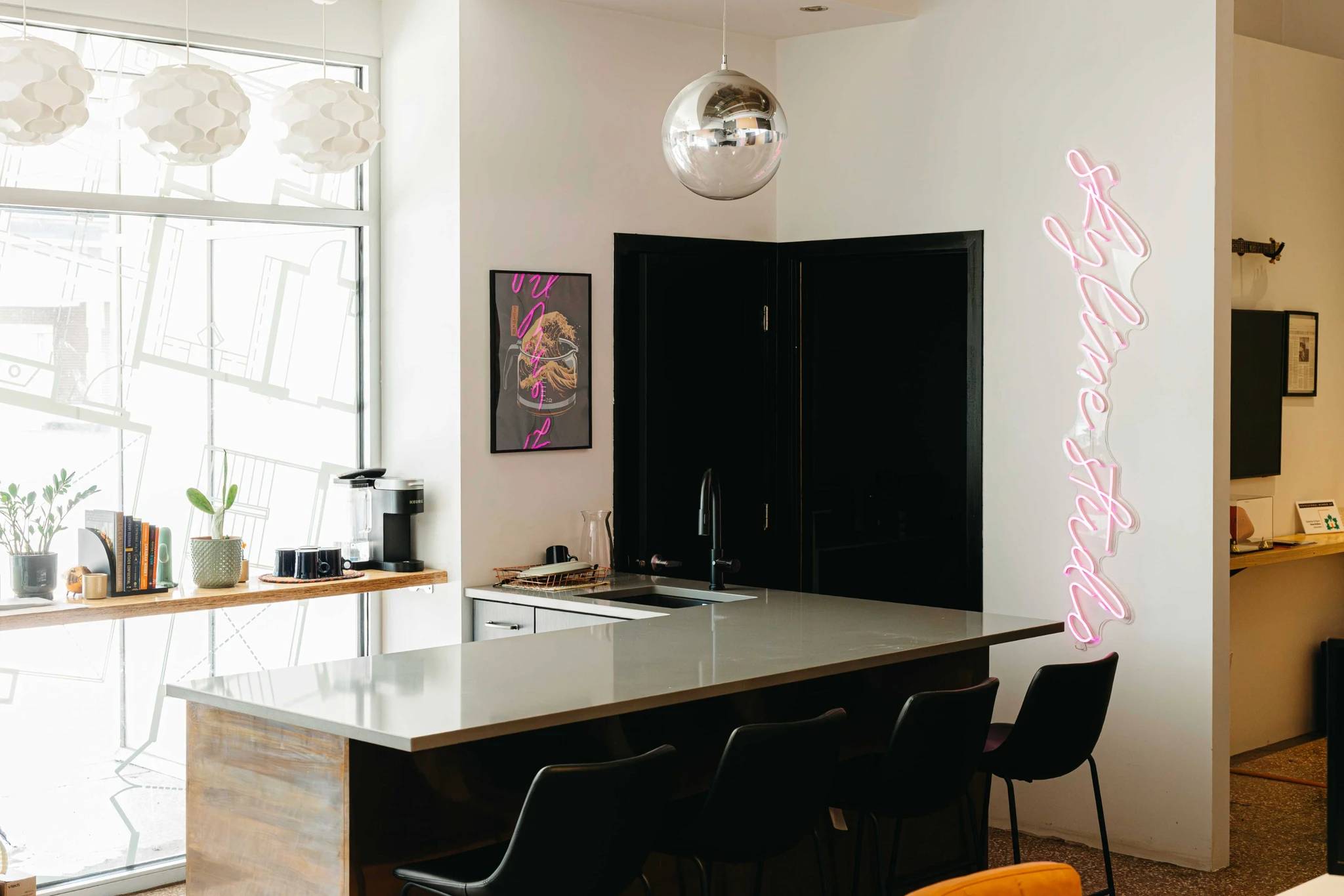 Skyline office in Saskatoon with a bar and four bar stools in front of a sunny window