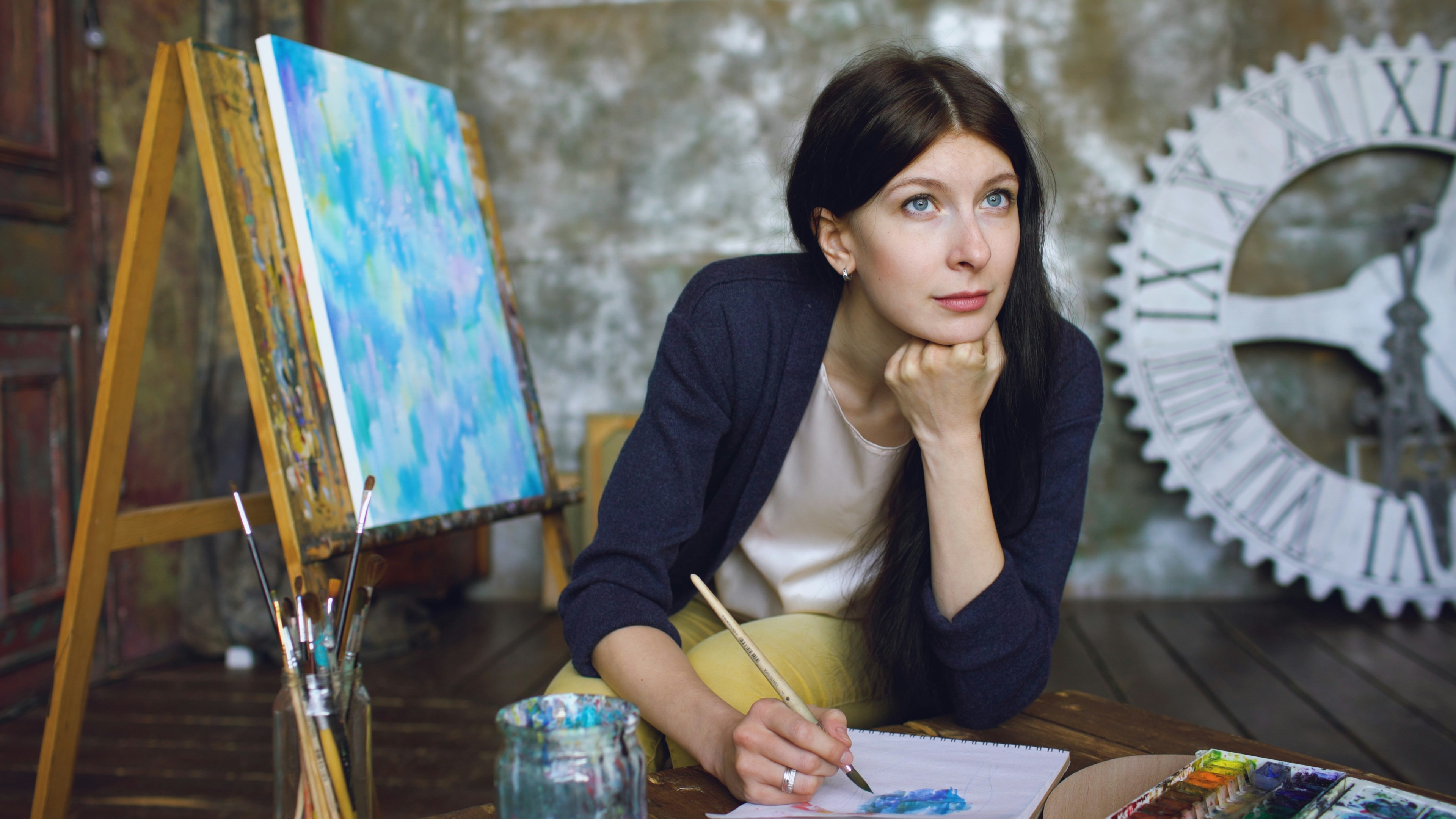 Artist contemplating her work in a studio