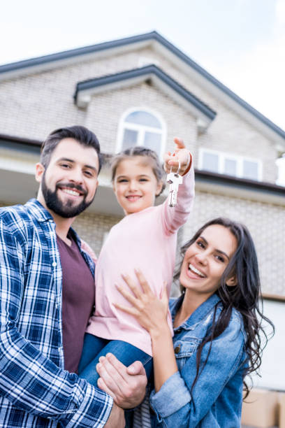 A happy family holding their property keys