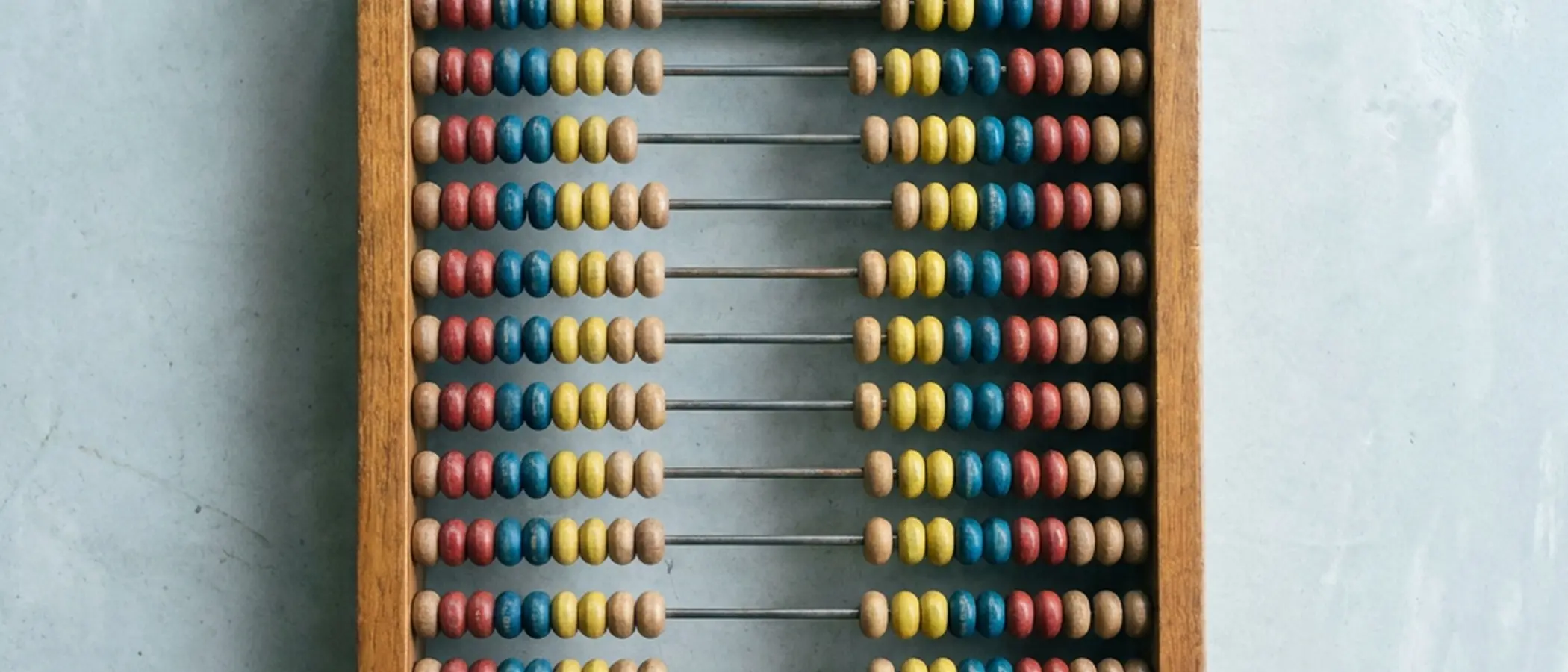 Wooden abacus with red, blue, and yellow beads.