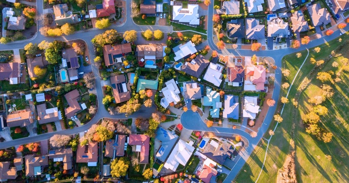 Aerial view of suburban homes with autumn foliage.