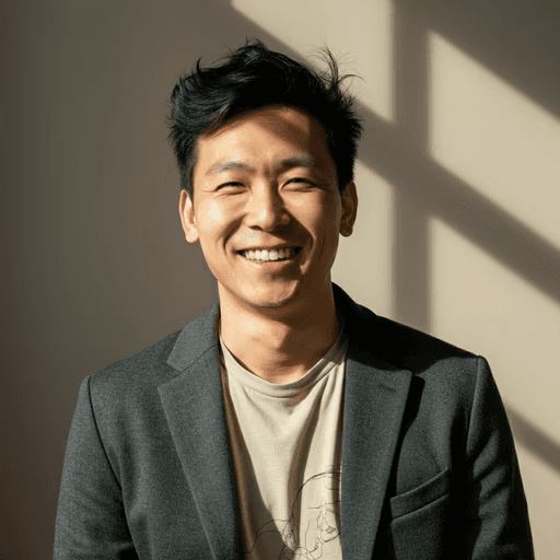 A person wearing the grey coat smiling in a cozy sunlight