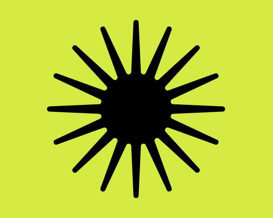 A close-up of a hand wearing multiple decorative rings against a blue background.