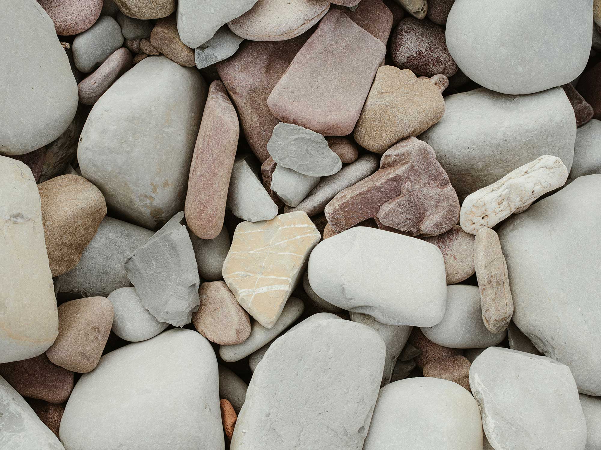 Picture of a pile of rocks in varyied gray tones often found on Bay Area Beaches