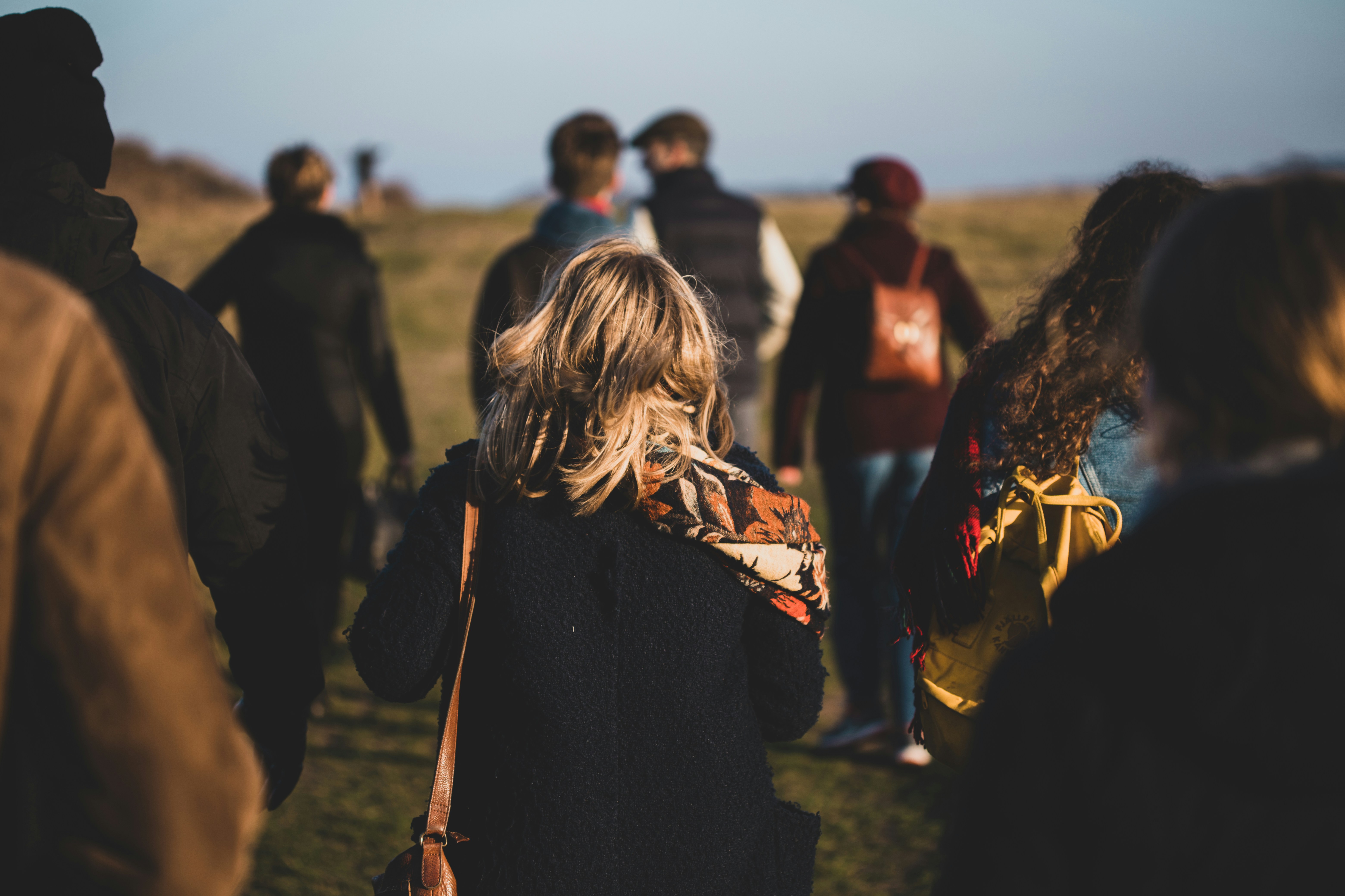 A group of young adults walking outside