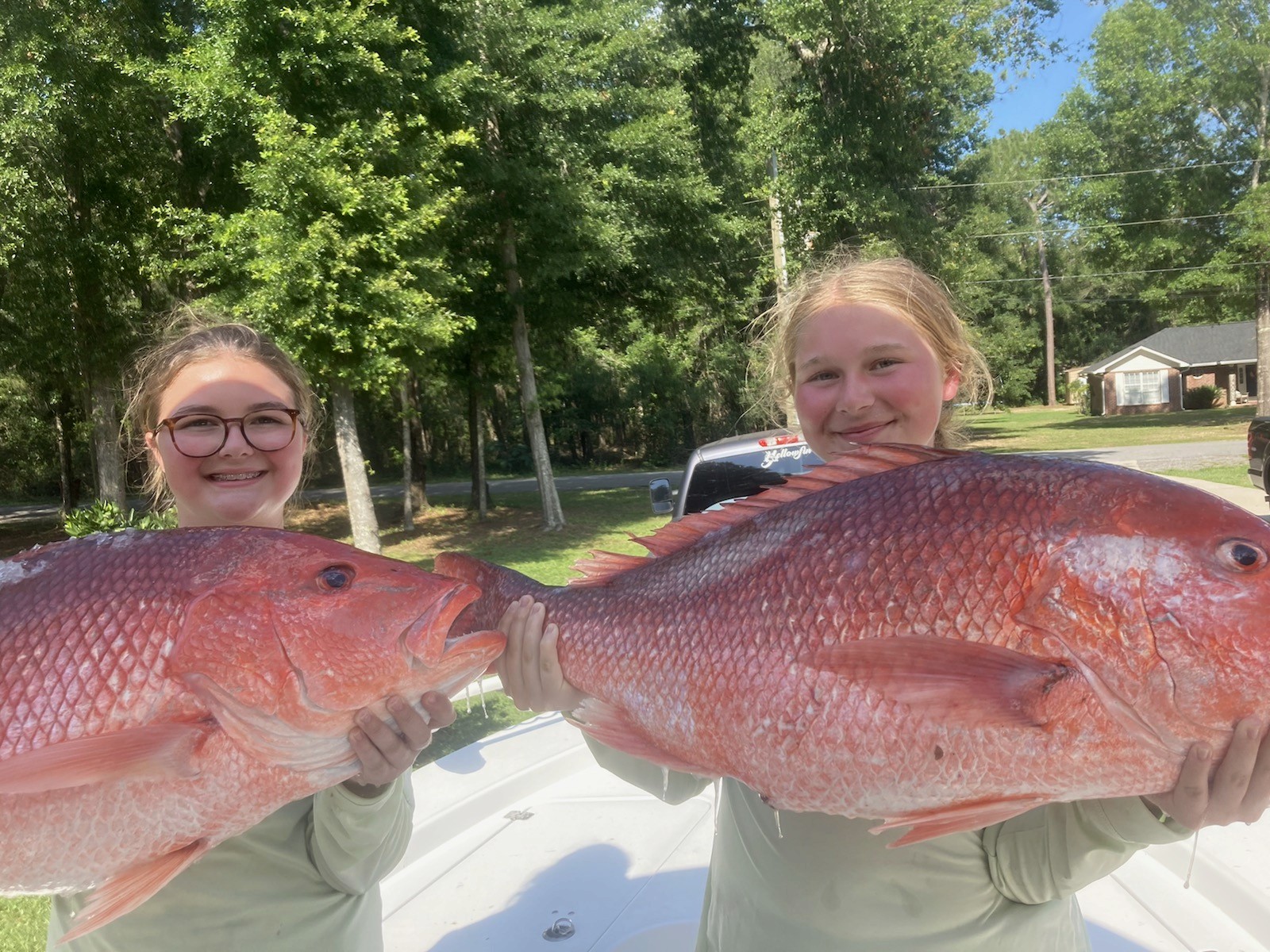 Girls holding Red Snapper