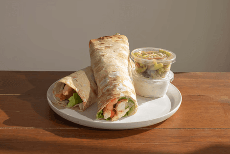 tray of rosemary chicken, tray of steamed veggies, brown rice, and lemon bars
