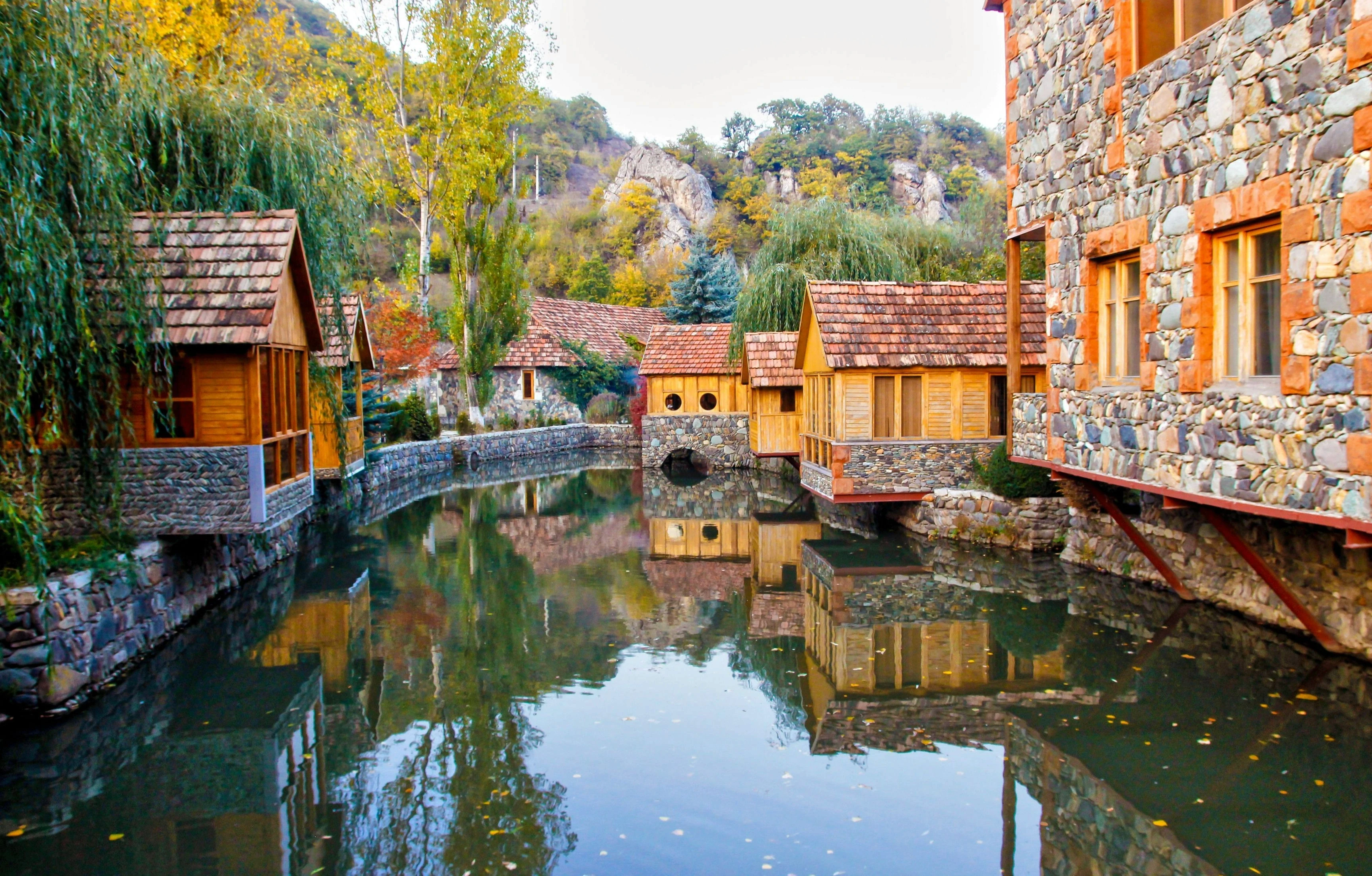 Stone cottages by riverside village