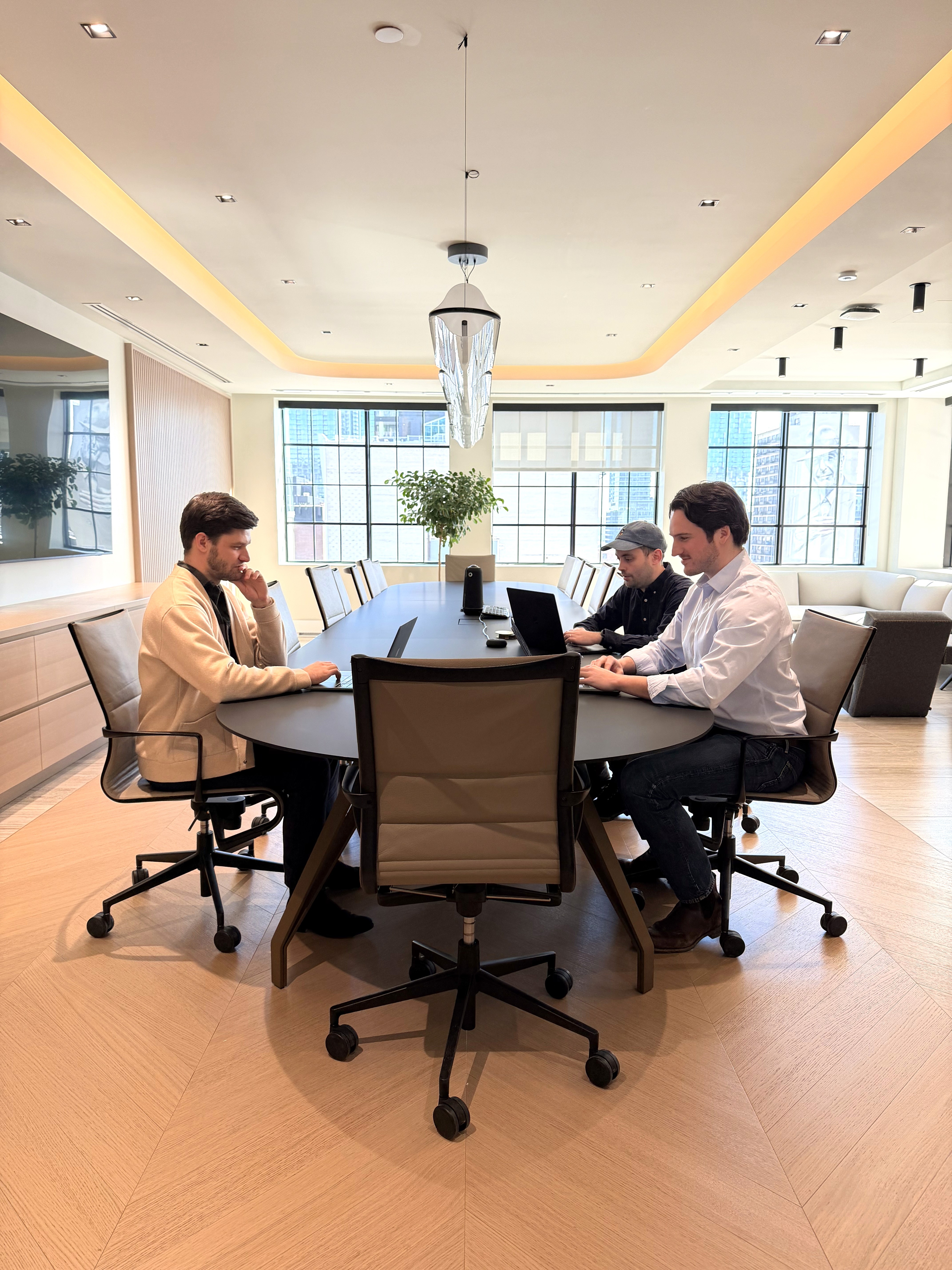 Smiling man wearing glasses and a pink shirt, showing his arm with a bandage after vaccination.
