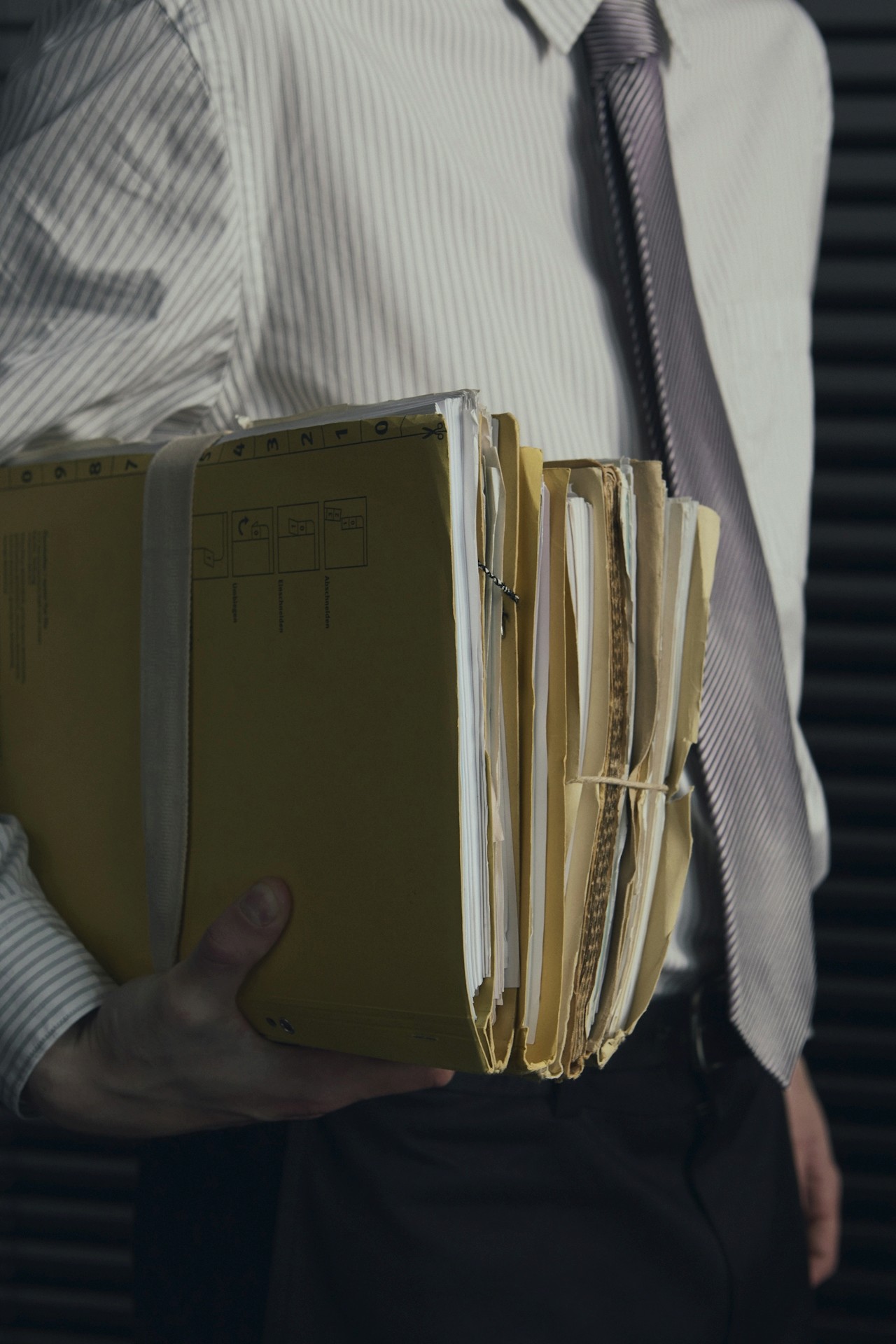 A shot of a man holding office files