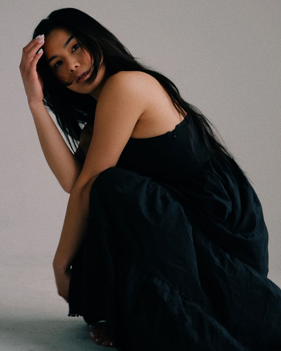 Woman with red hair covering mouth with hair