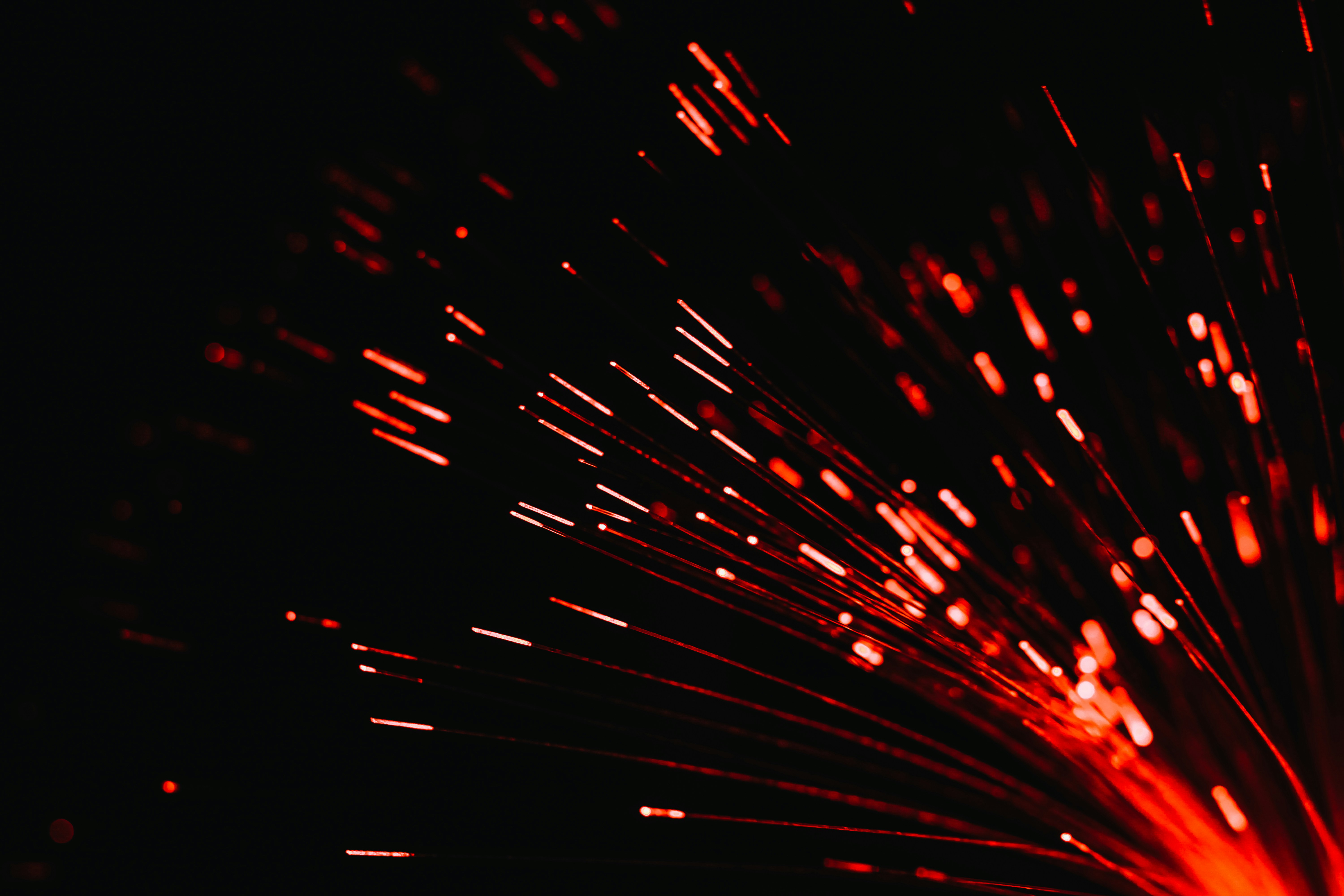 A close up of a red firework in the dark