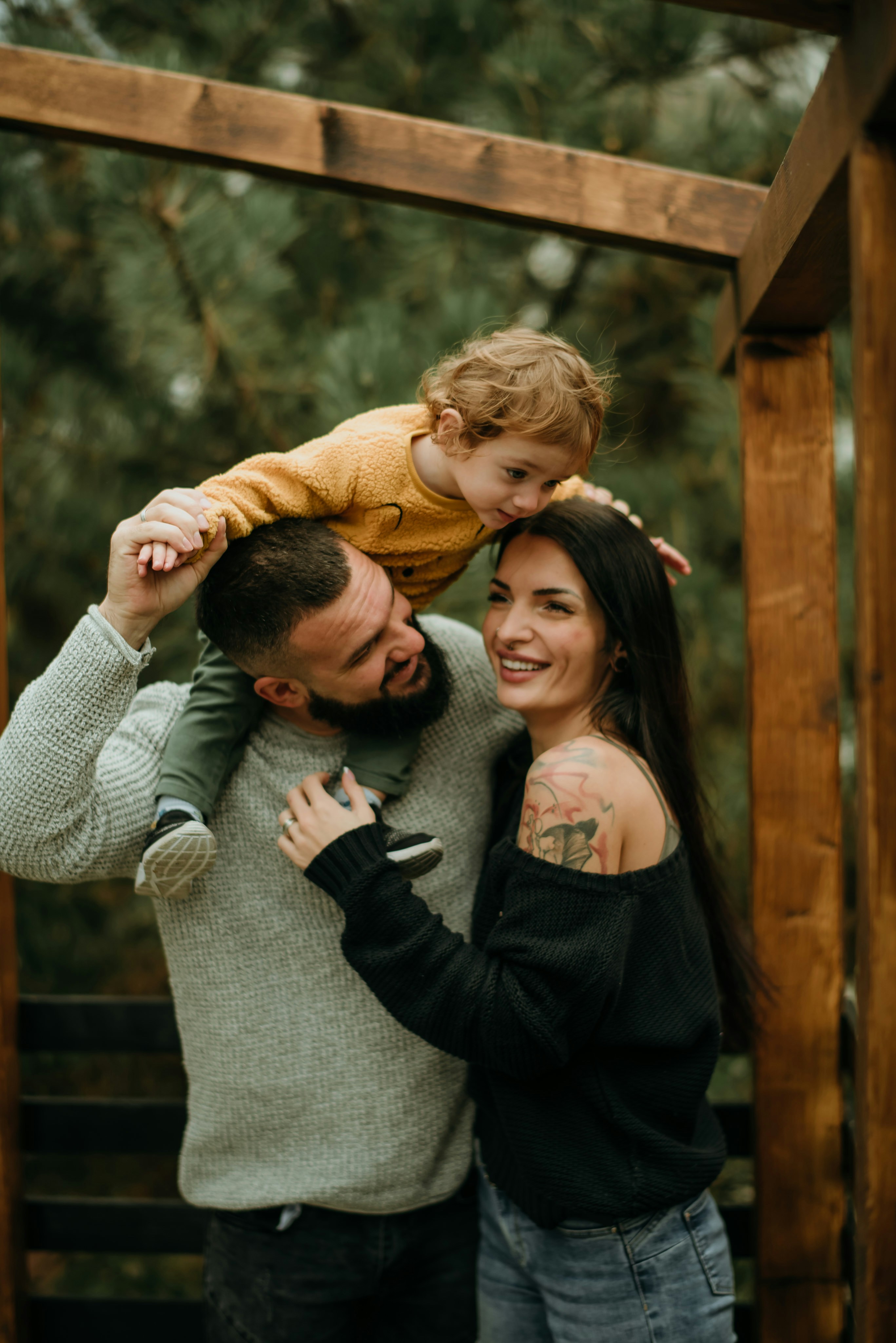 a man and woman holding a small child in their arms