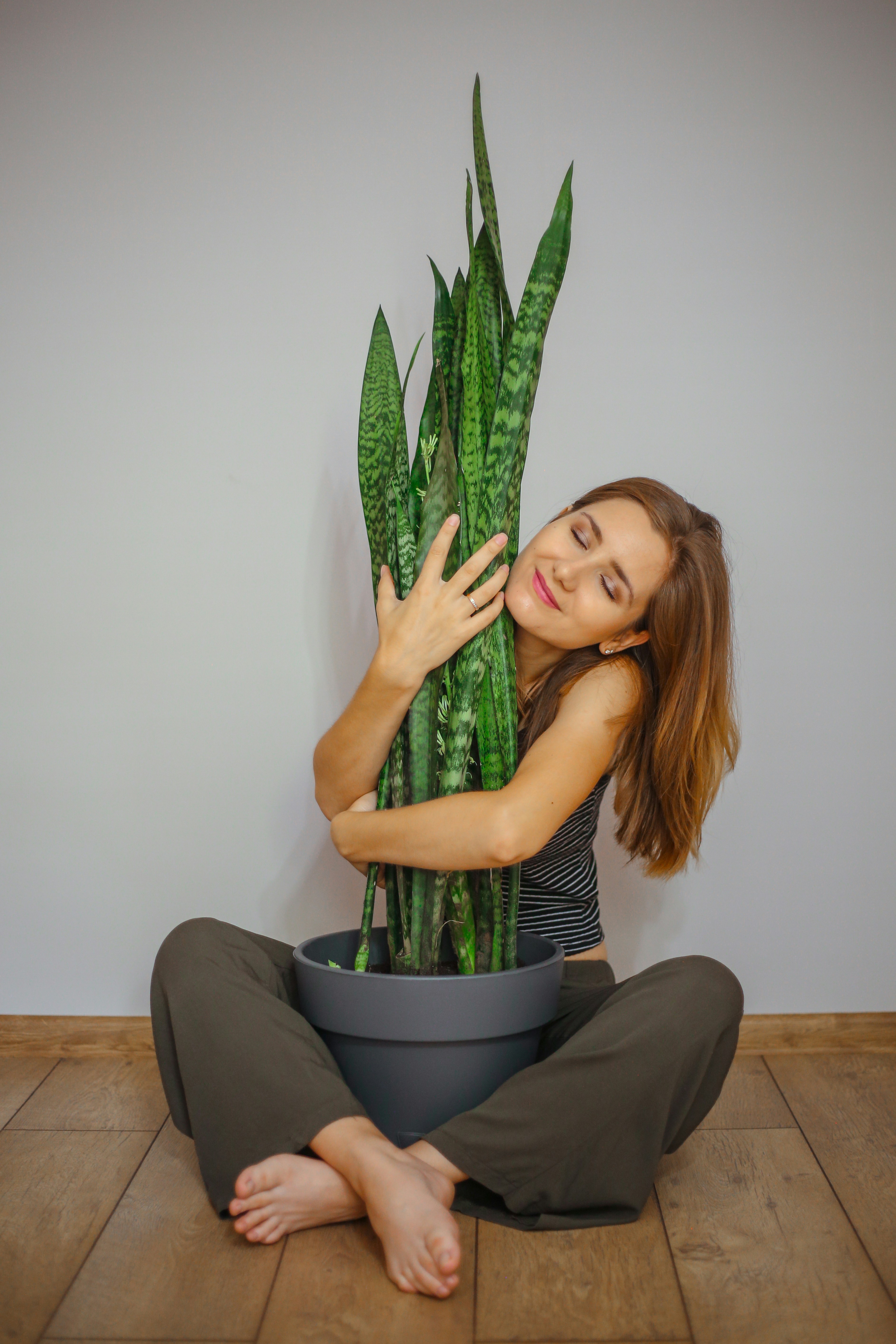 woman in black and red striped shirt and black pants sitting on black chair