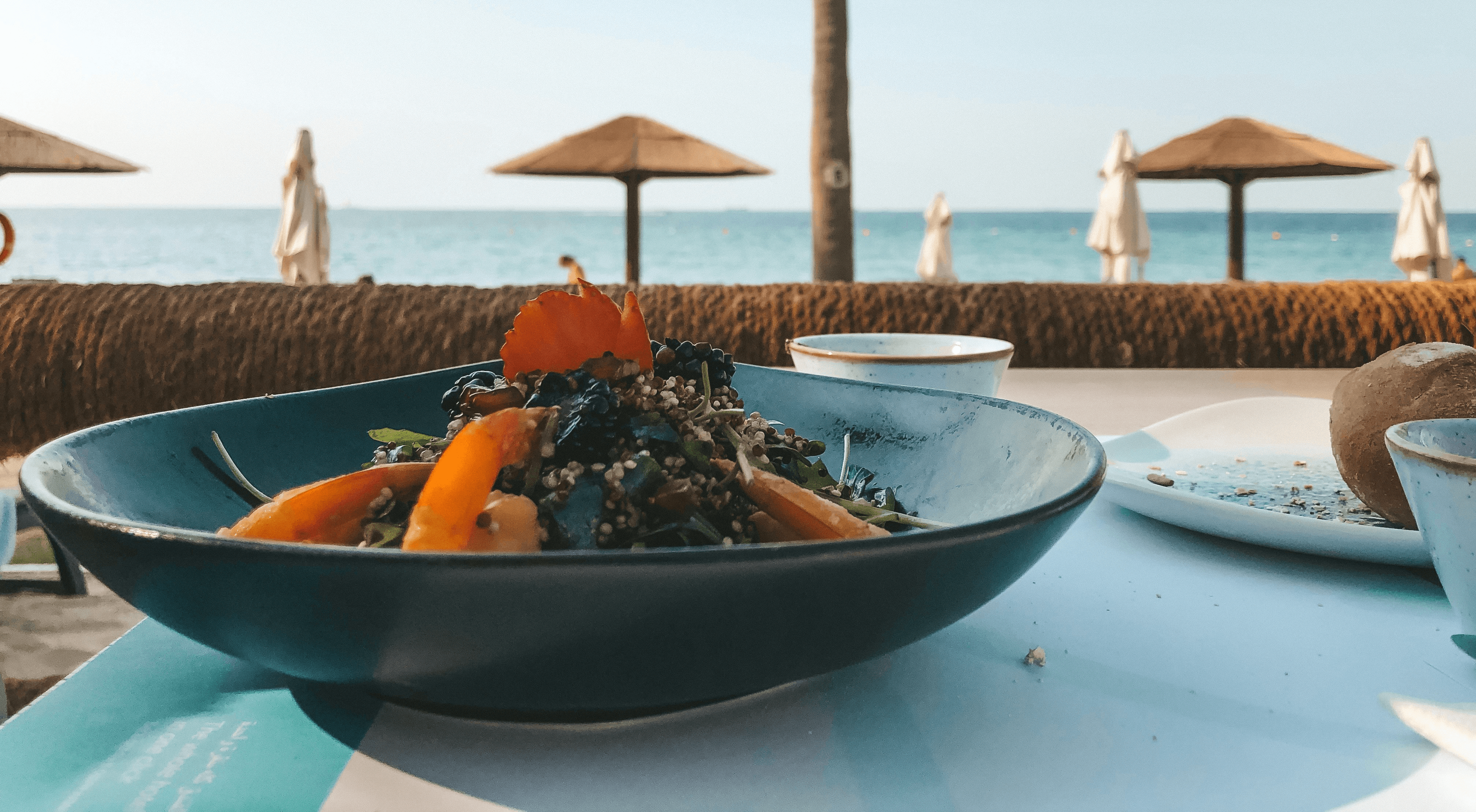 sliced tomato on black ceramic bowl on white table