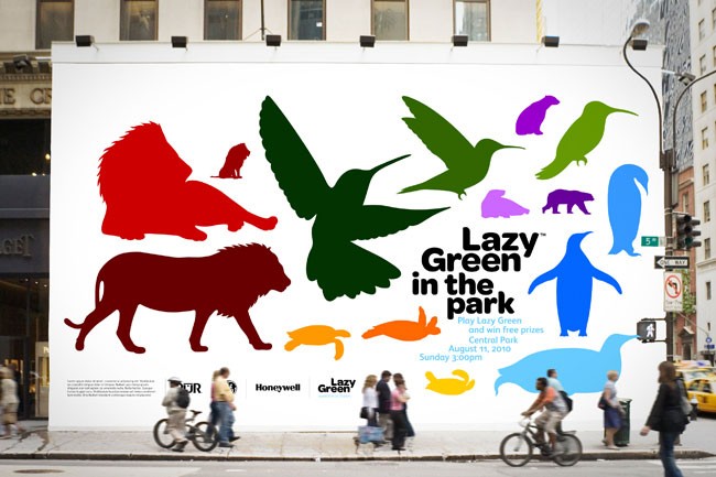 A large white wall displays a colorful mural featuring silhouettes of various animals, including a lion, bird, hummingbird, penguin, seal, turtle, dog, cat, bird, turtle, and penguin. The mural is titled “Lazy Green in the Park” with additional text indicating prizes and dates: “Play Lazy Green and win free prizes, Sunday August 11, 2010 3:00pm”. People walk and cycle along the sidewalk in front of the mural.