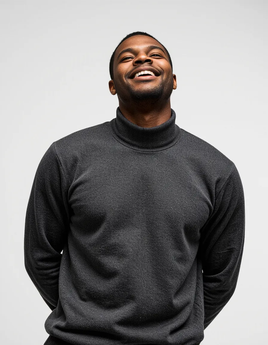 Professional portrait showing a joyful smile against white background, wearing a dark turtleneck sweater in minimalist style.