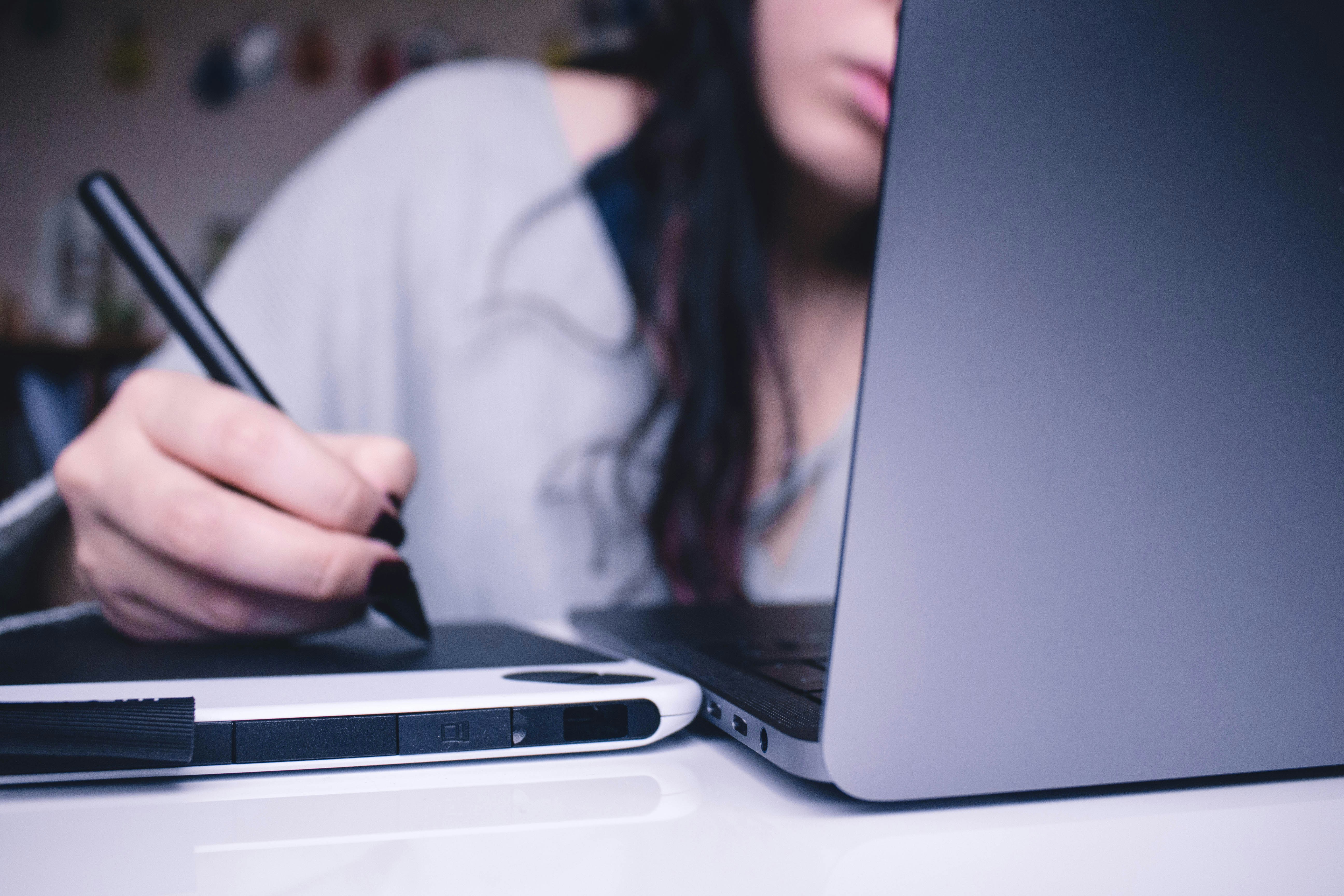 Girl Writing on Tablet while Using Laptop - Shelf Exam Length