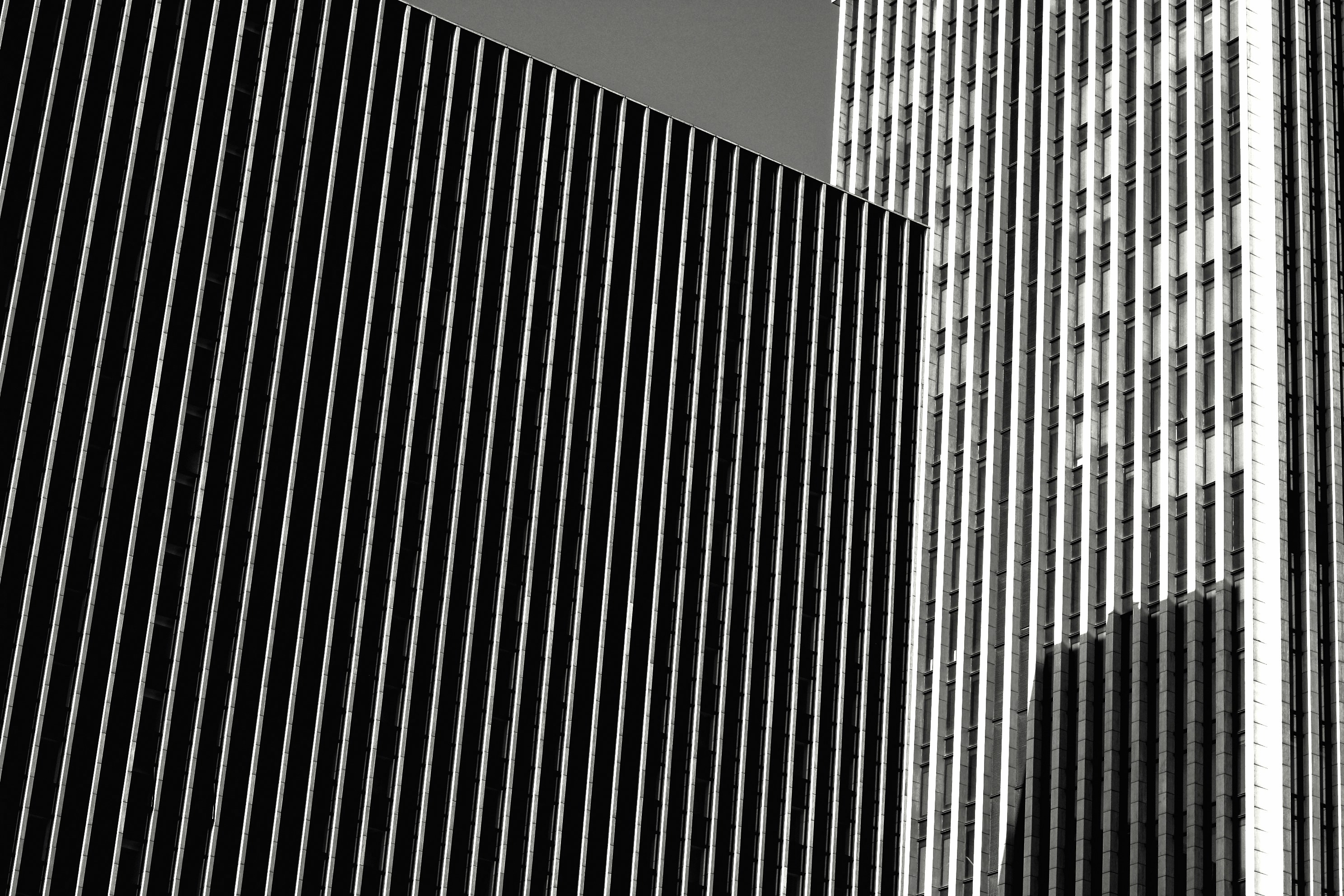a black and white photo of two tall buildings